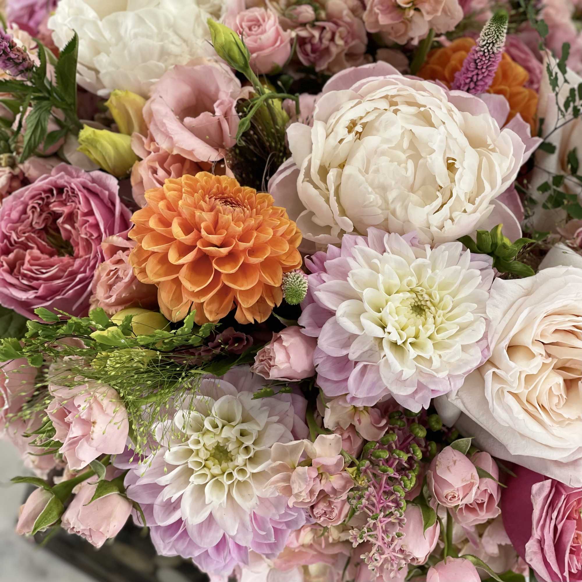 Mixed bouquet of pink, white, and orange flowers