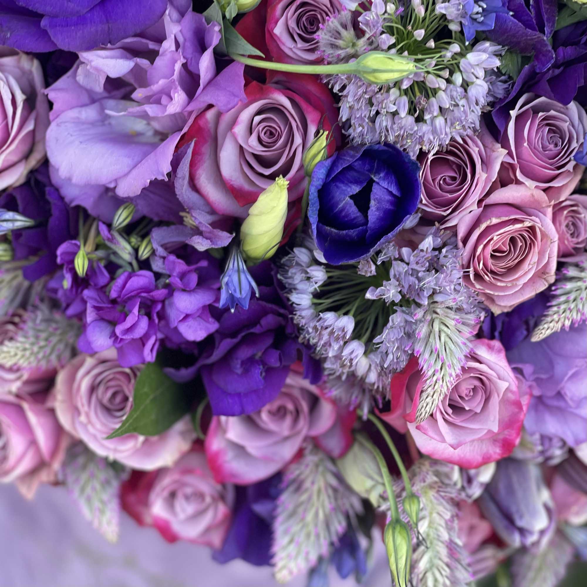 Purple and pink bouquet with roses and mixed blossoms