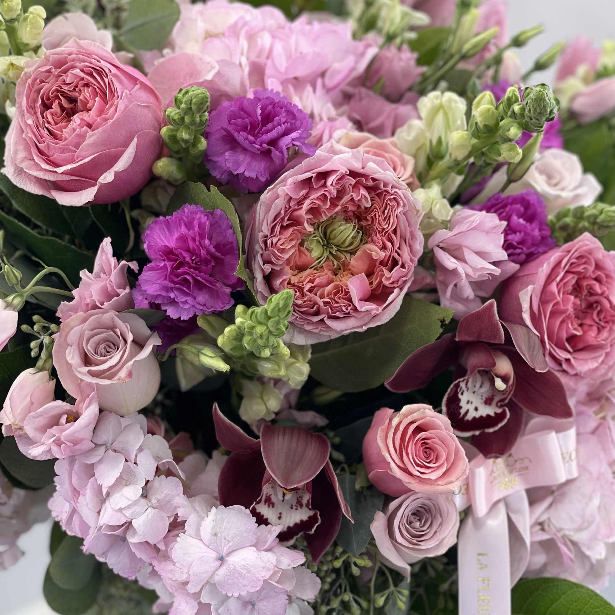 Pink and purple bouquet with roses, orchids, and hydrangea