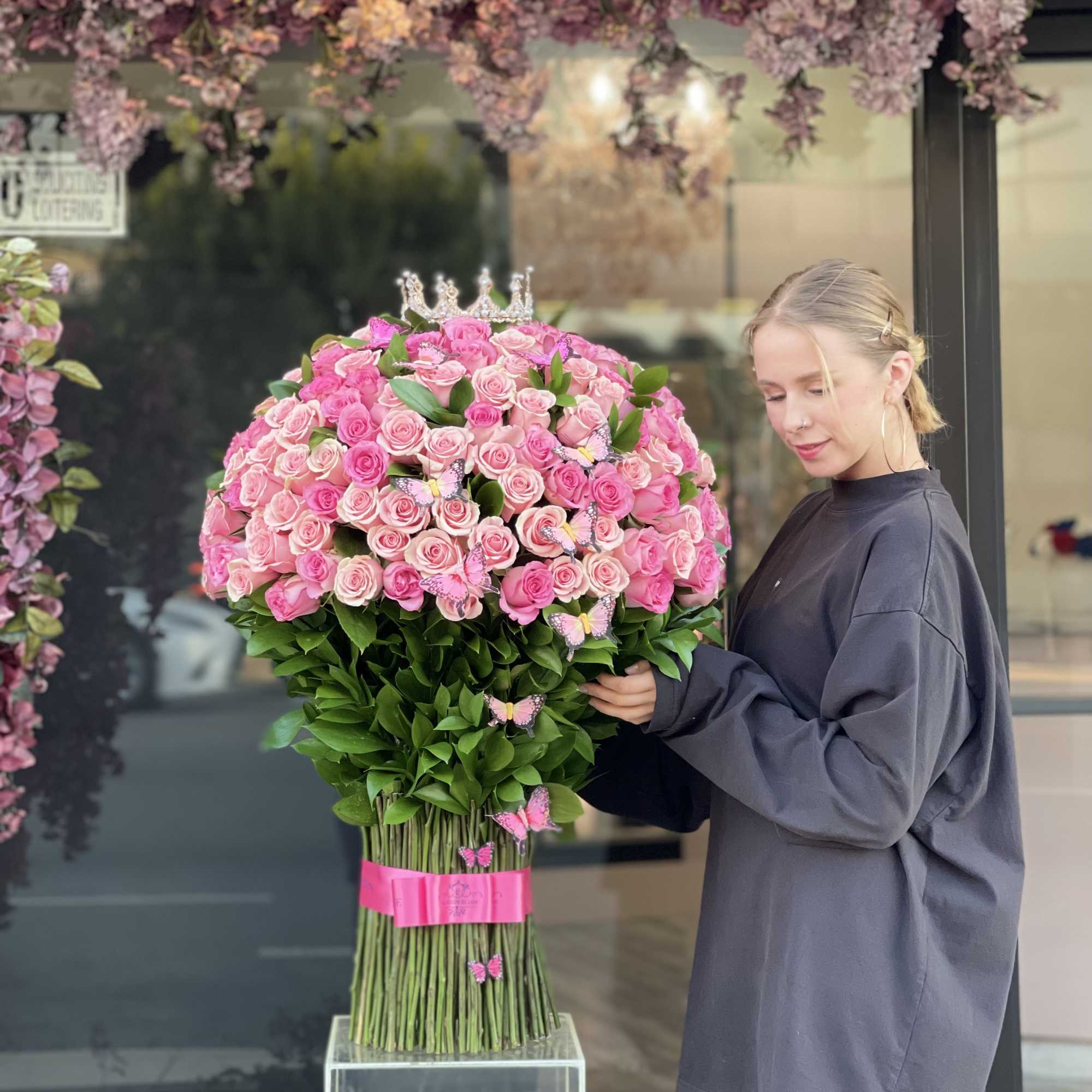 Large bouquet of pink roses with a crown topper