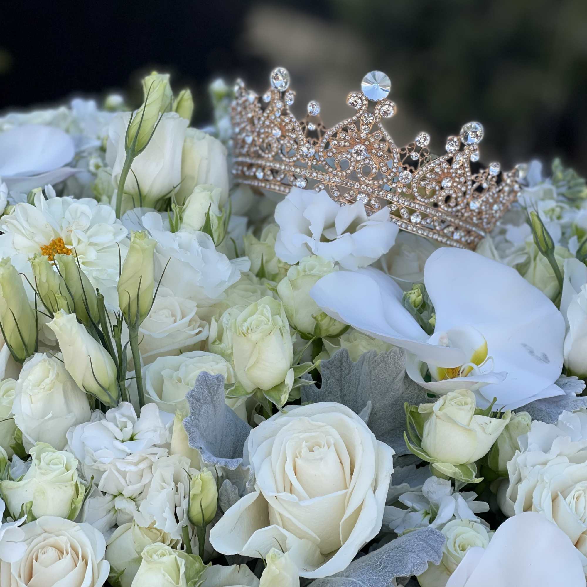 White rose bouquet with a jeweled tiara on top