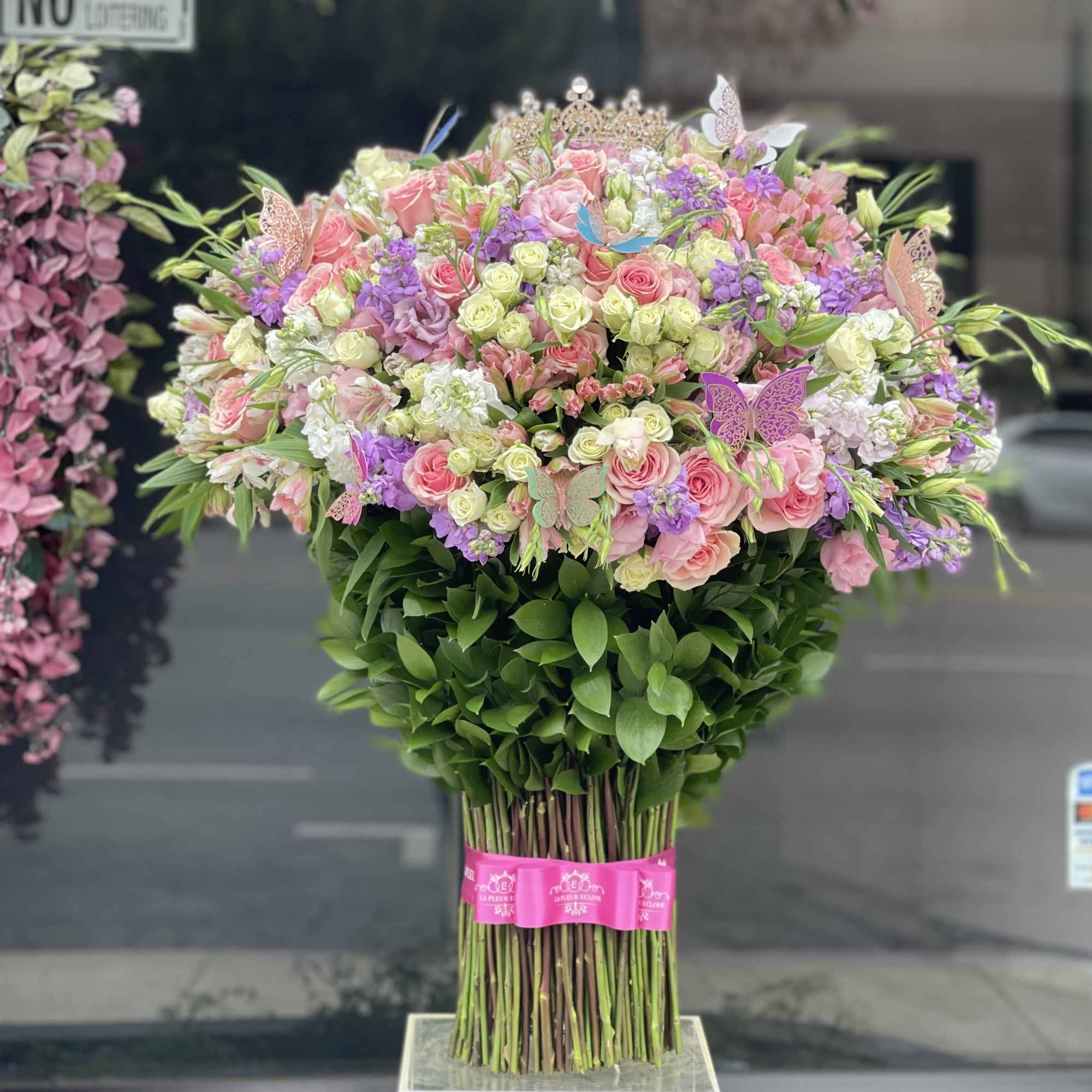 Large bouquet of pink and purple flowers with butterflies