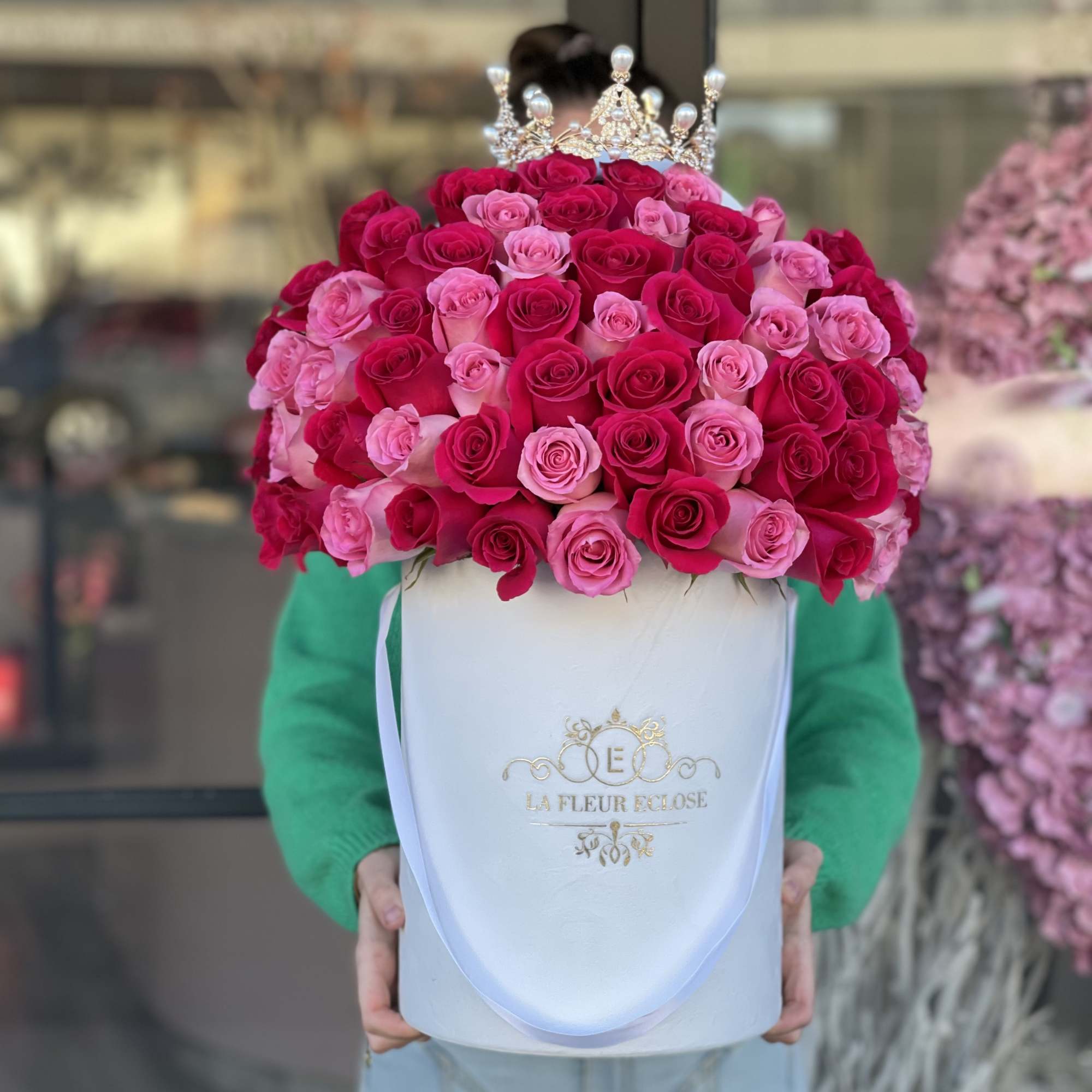 Pink and red rose bouquet in a white hat box with a jeweled crown topper