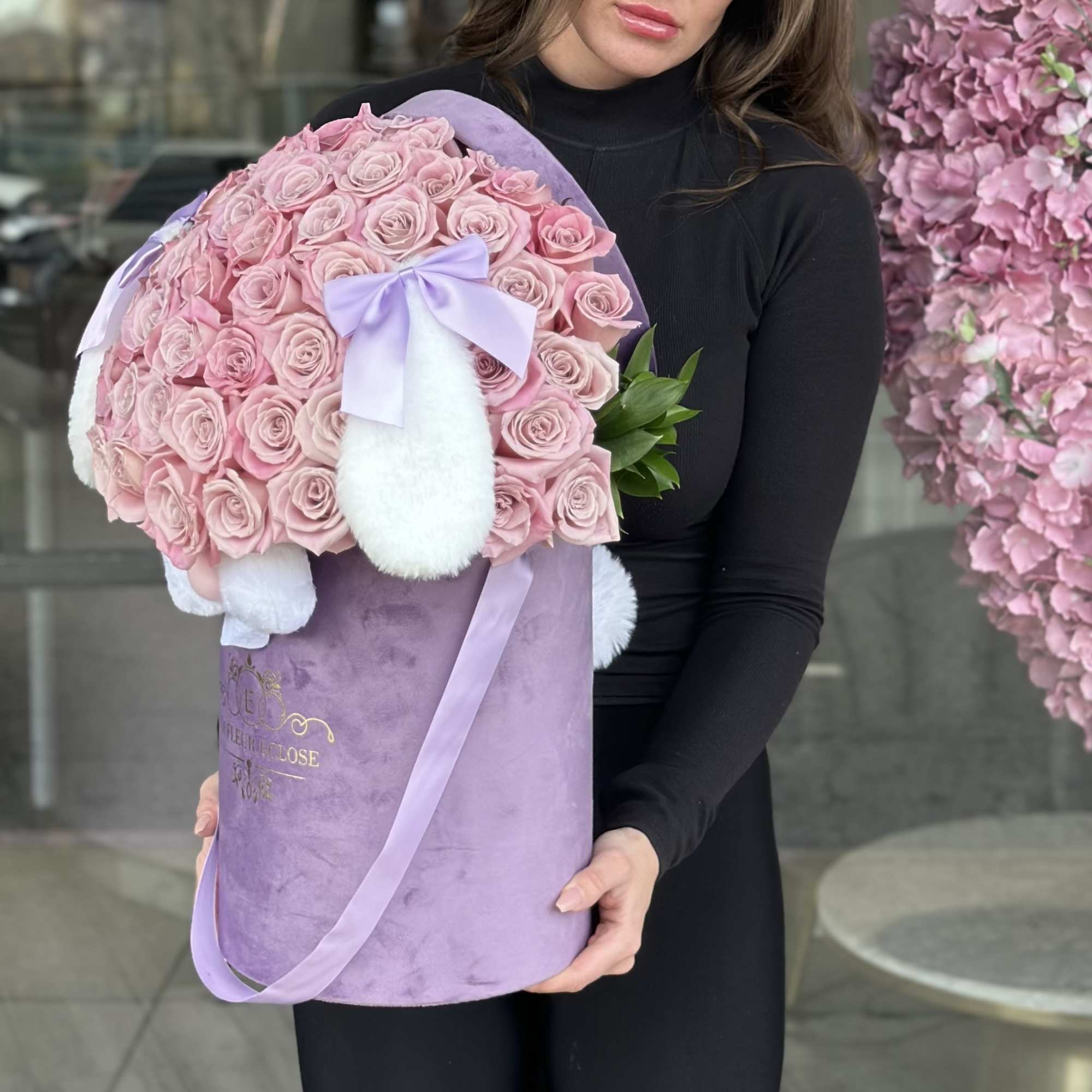 Large bouquet of pink roses in a lavender hatbox with a bow
