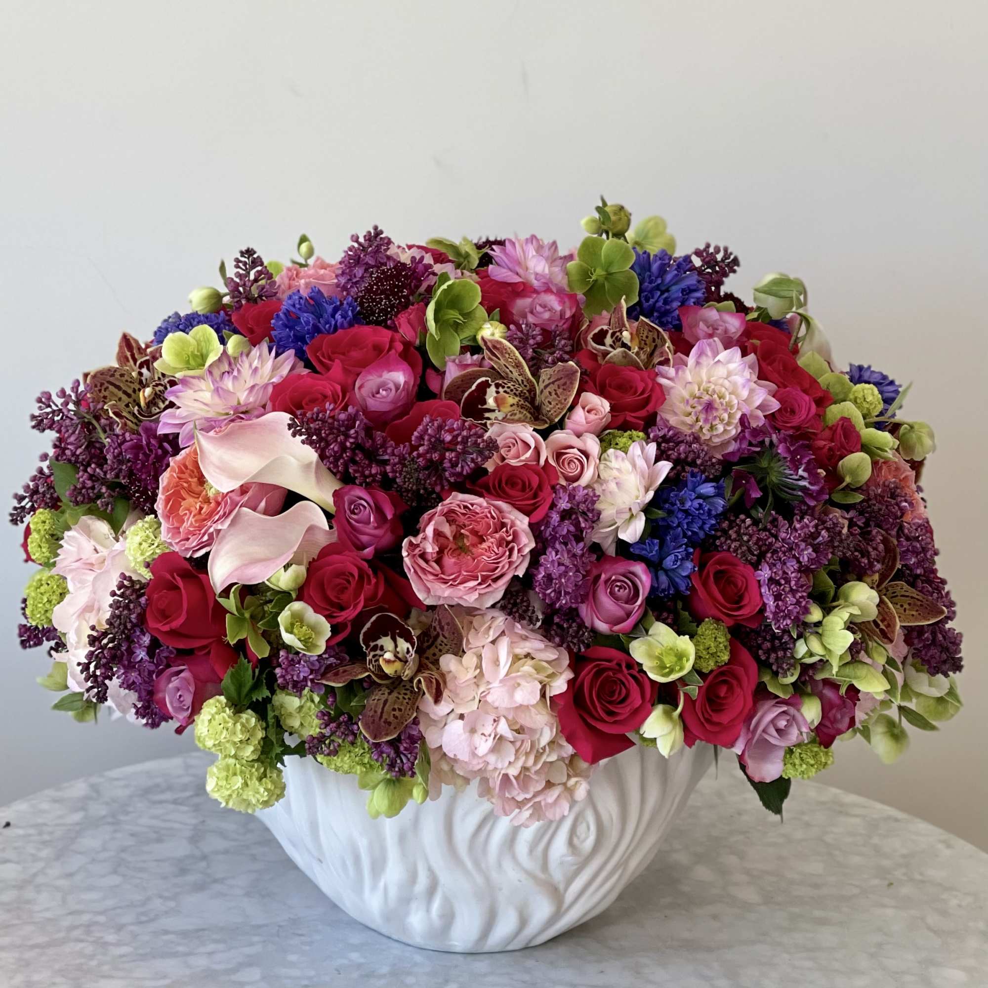 Mix of colorful flowers in a vase 

Standard- as you see on