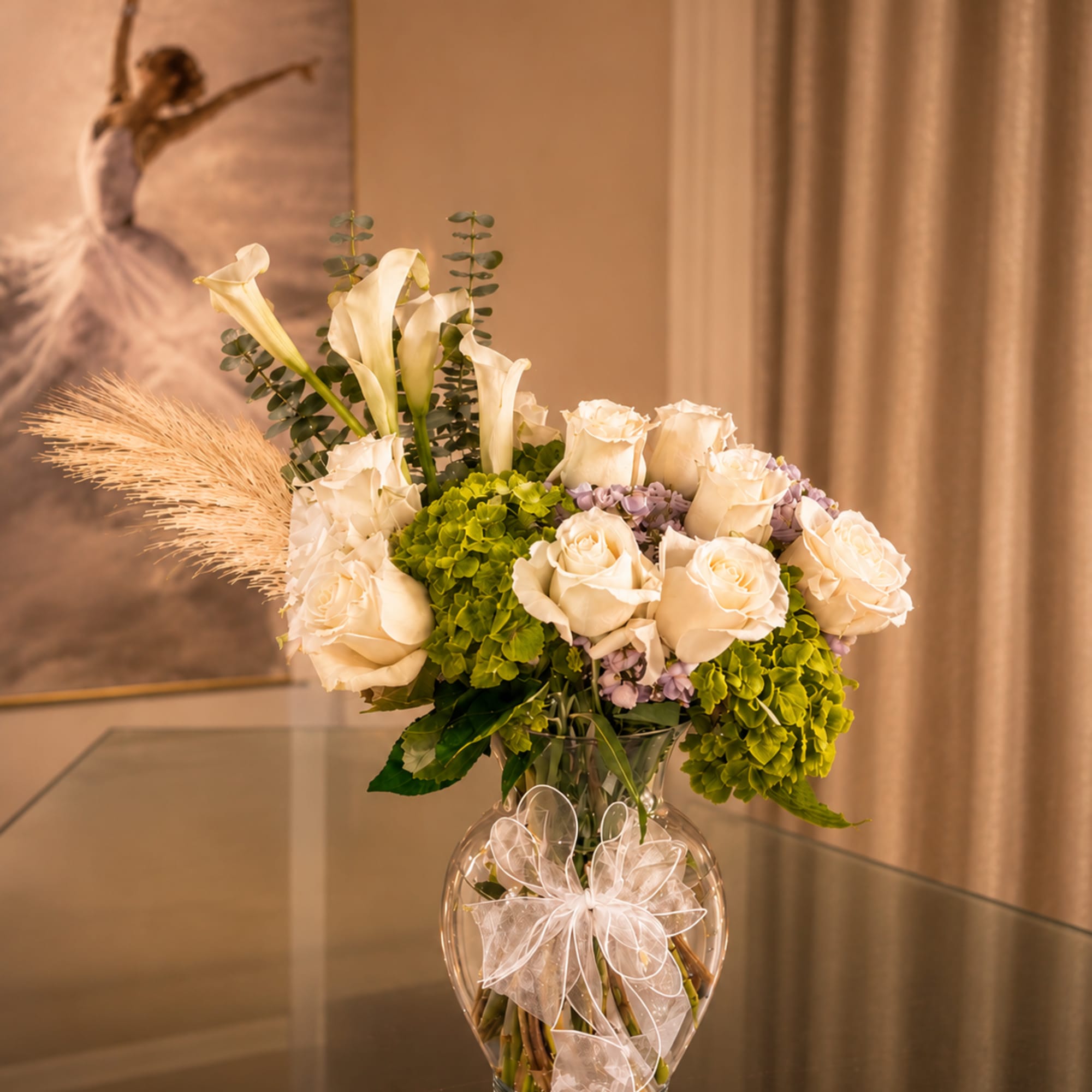 A luminous couture-style arrangement where ivory roses bloom like porcelain silk against