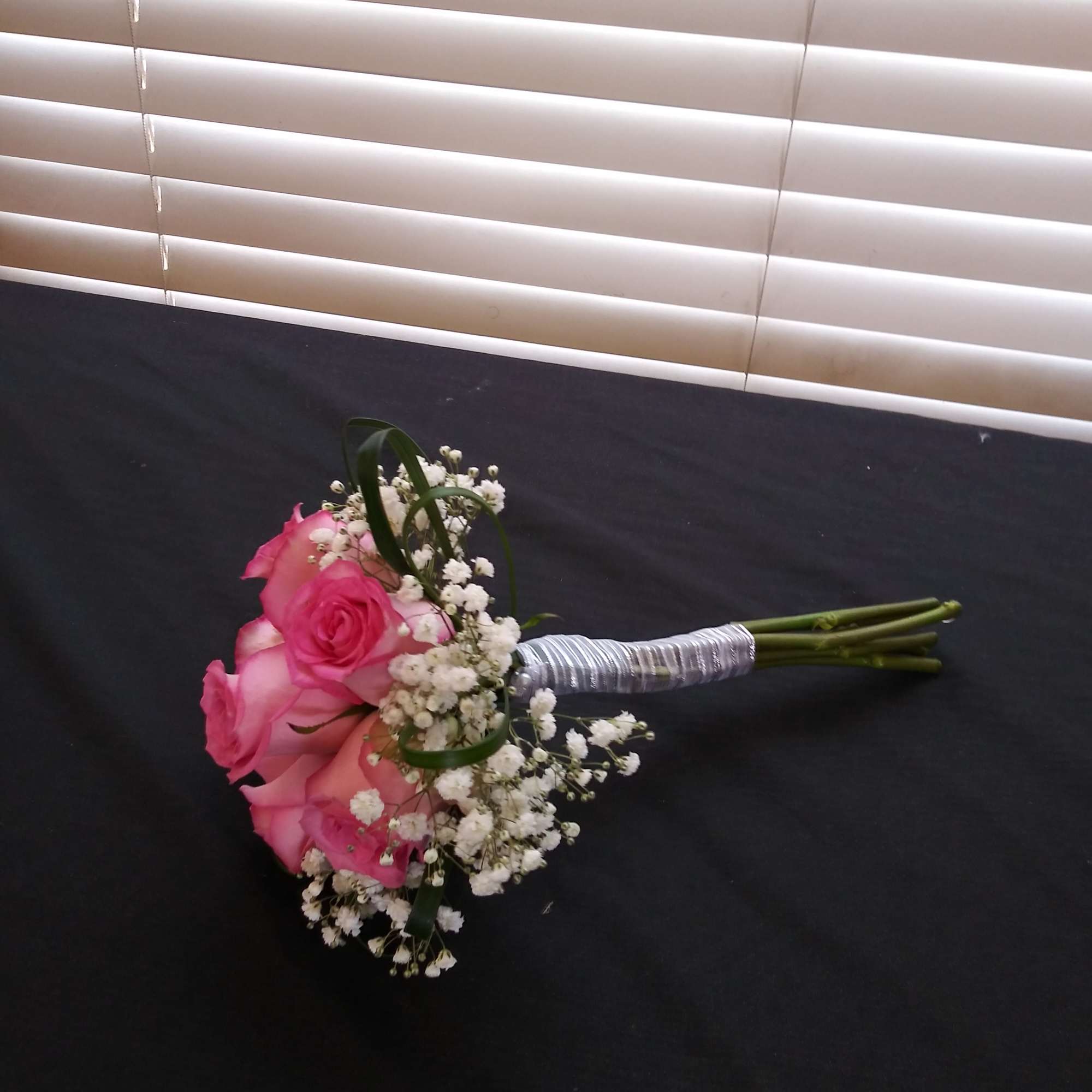 Pink rose bouquet with baby's breath and wrapped stems