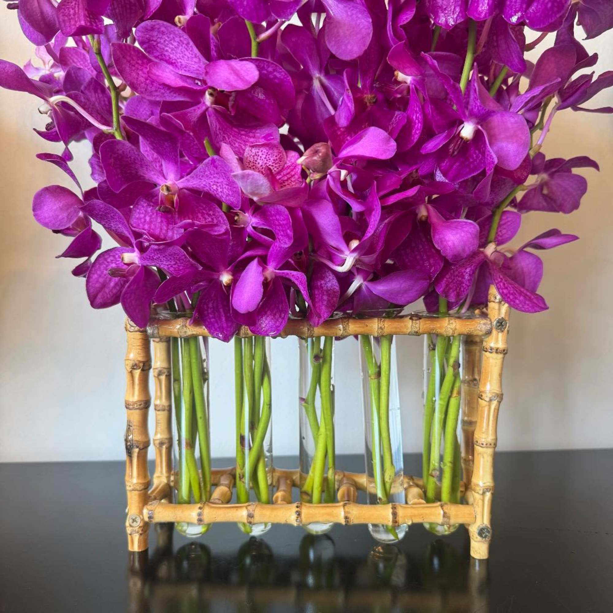An elegant, striking design featuring tropical orchids arranged in a sleek bamboo