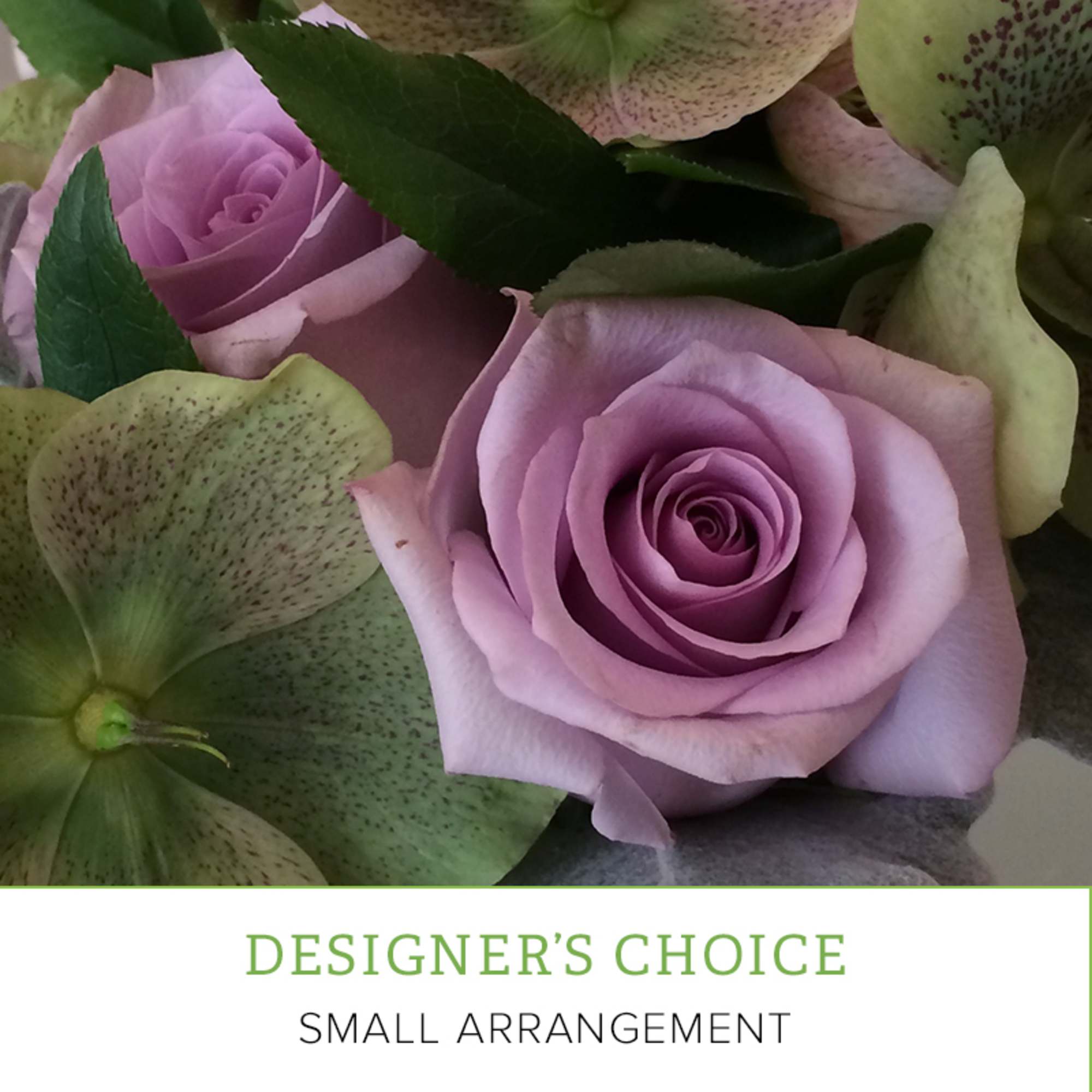 Lavender roses with pale green speckled lilies in a close-up arrangement
