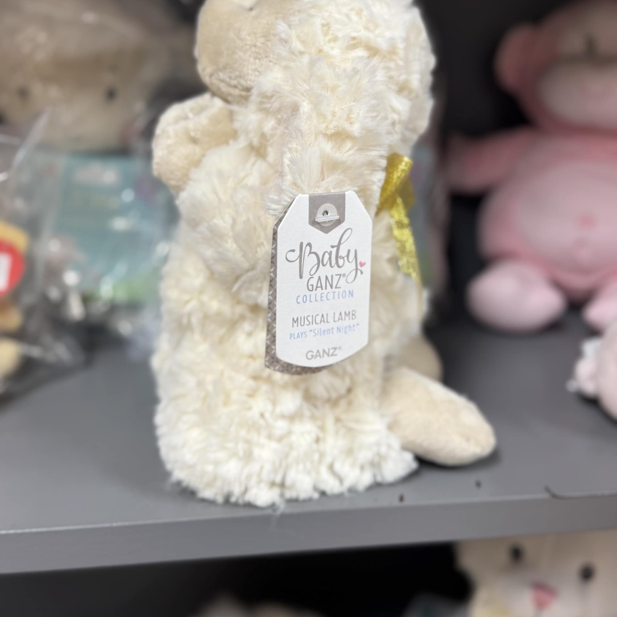 Cream plush lamb with a hanging product tag