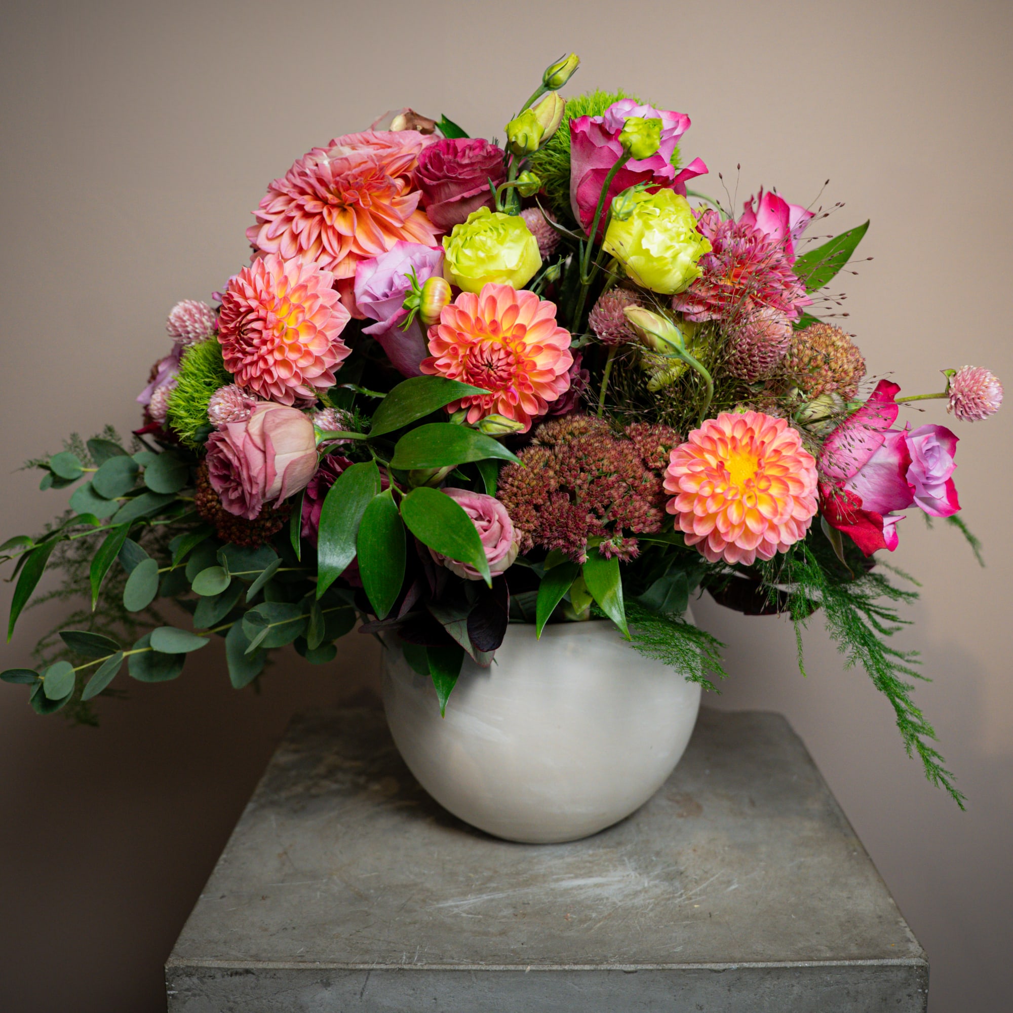 This arrangement of dahlias, roses, clover, dianthus, and more brings together an