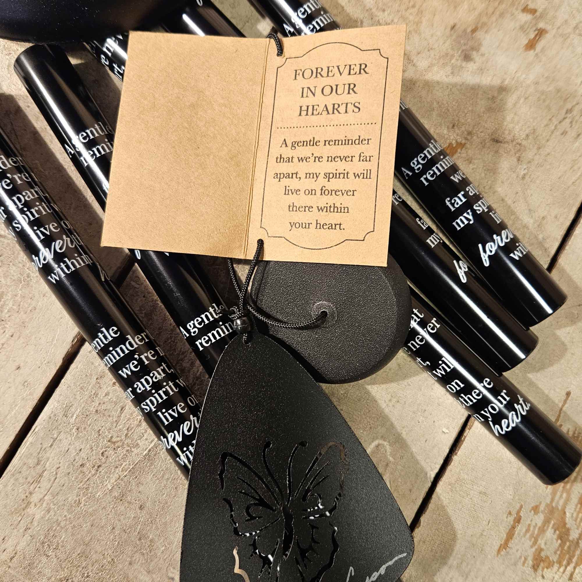 Black memorial candles with a sympathy tag and butterfly ornament