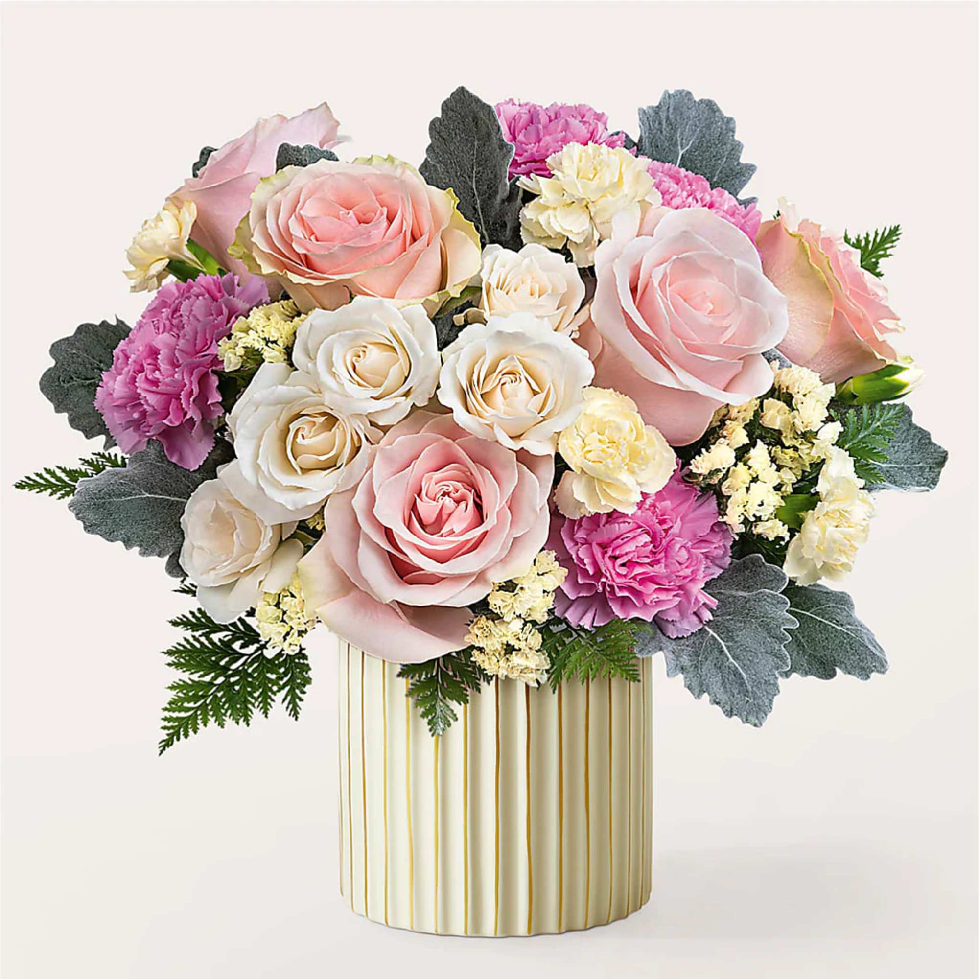Pink and white roses with carnations in a striped vase