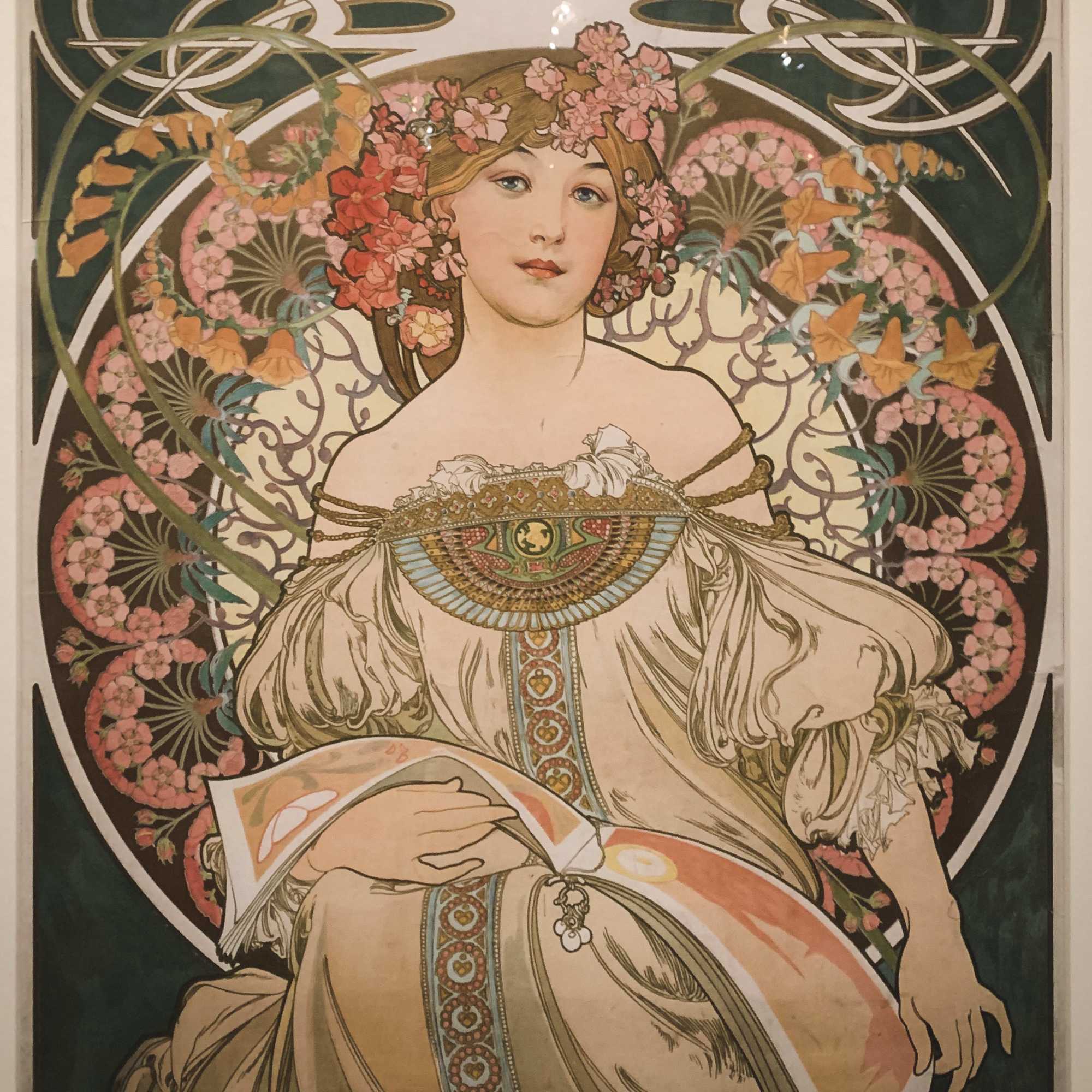 Art nouveau poster of a woman surrounded by floral motifs