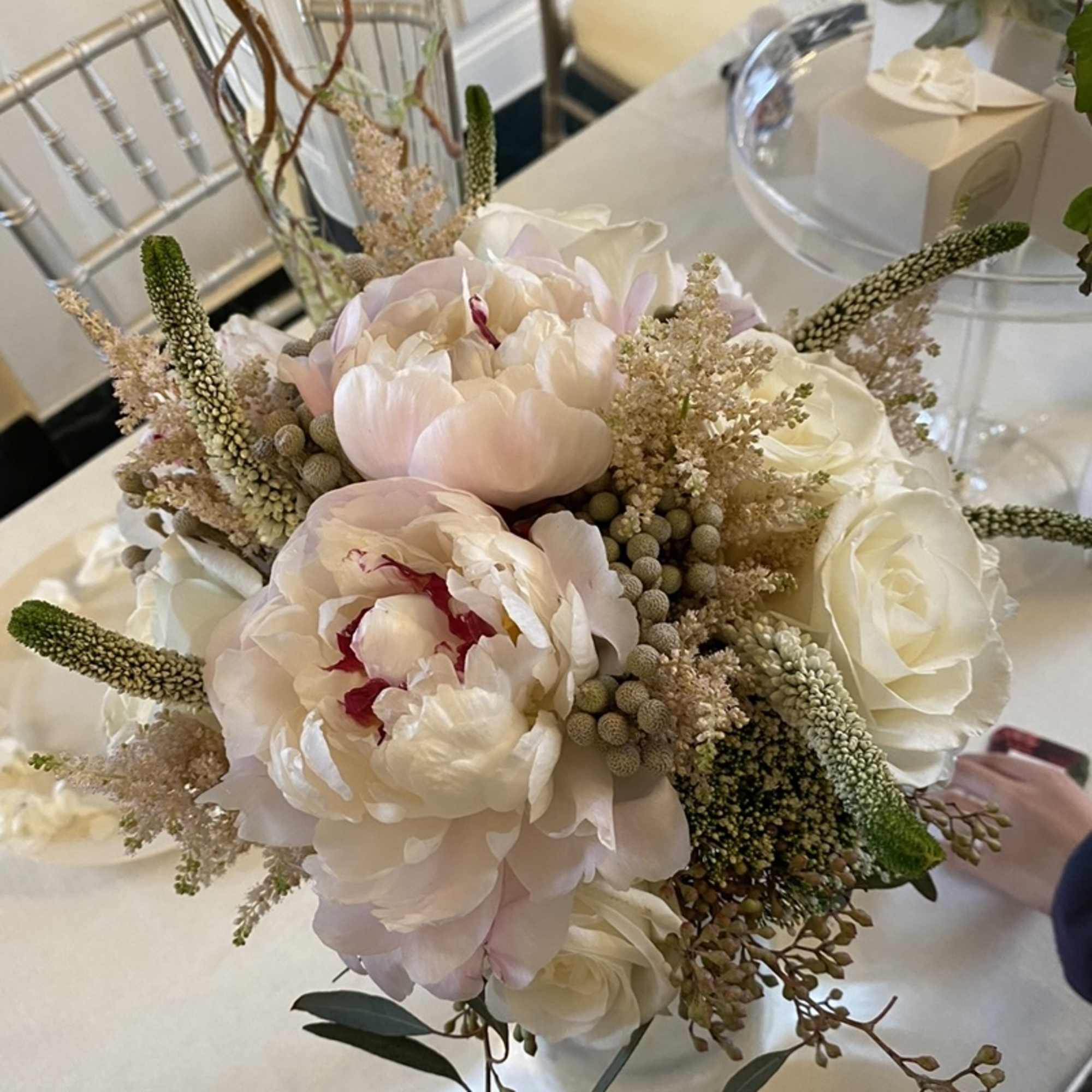 Soft pink and white bouquet with peonies and roses in a glass vase