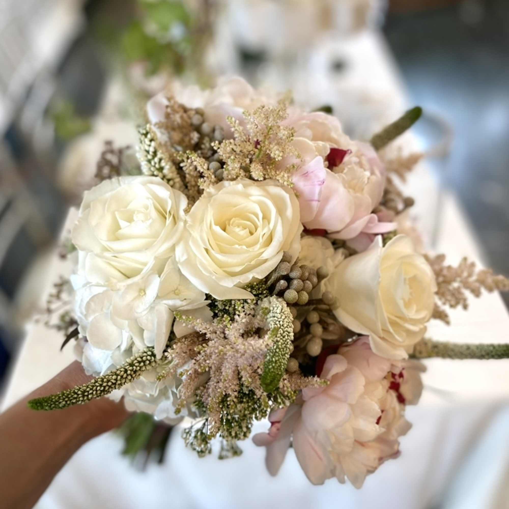 Small bouquet of cream roses and pale pink flowers