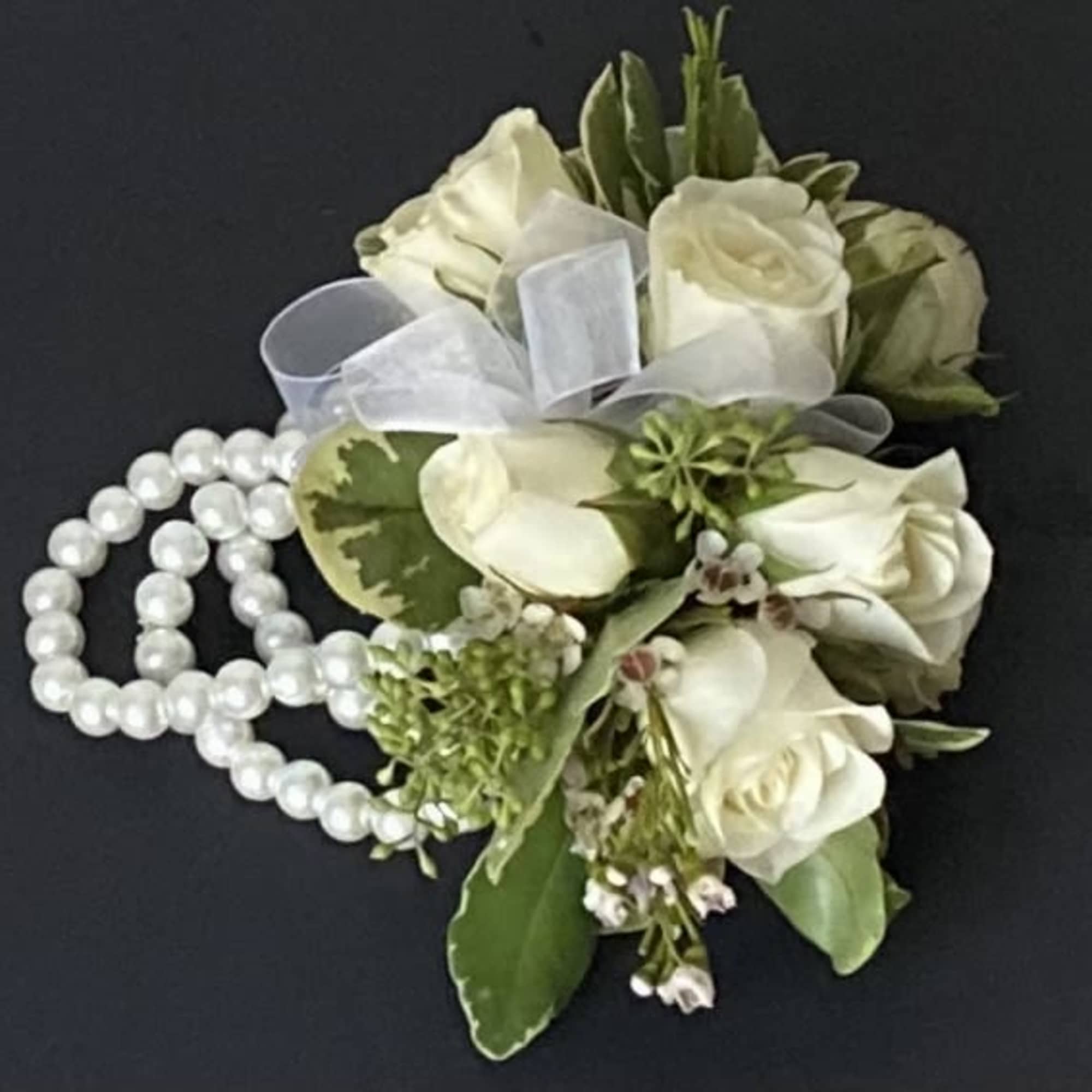 White rose corsage with pearl strands and a sheer ribbon