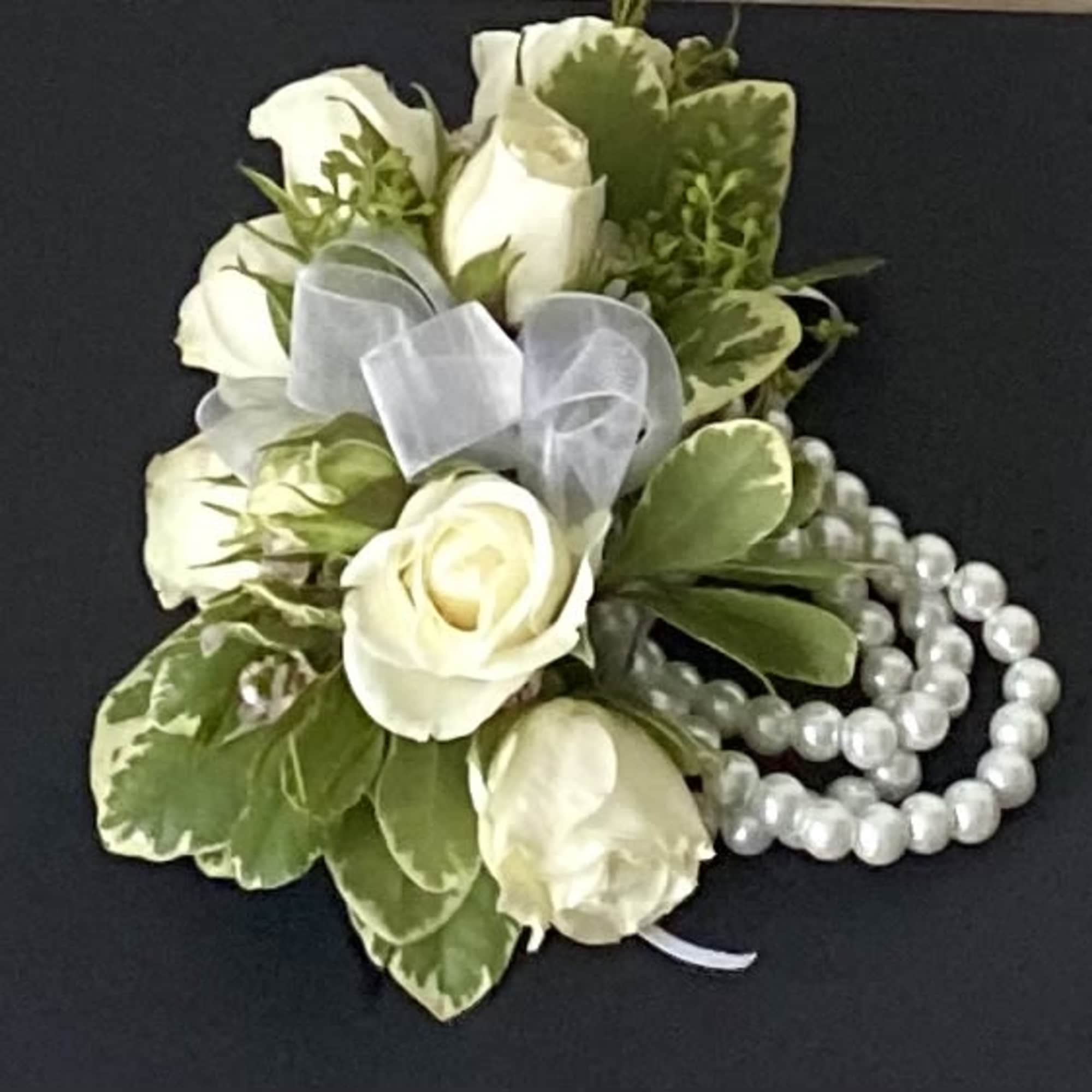 White rose corsage with a sheer ribbon and pearl strands
