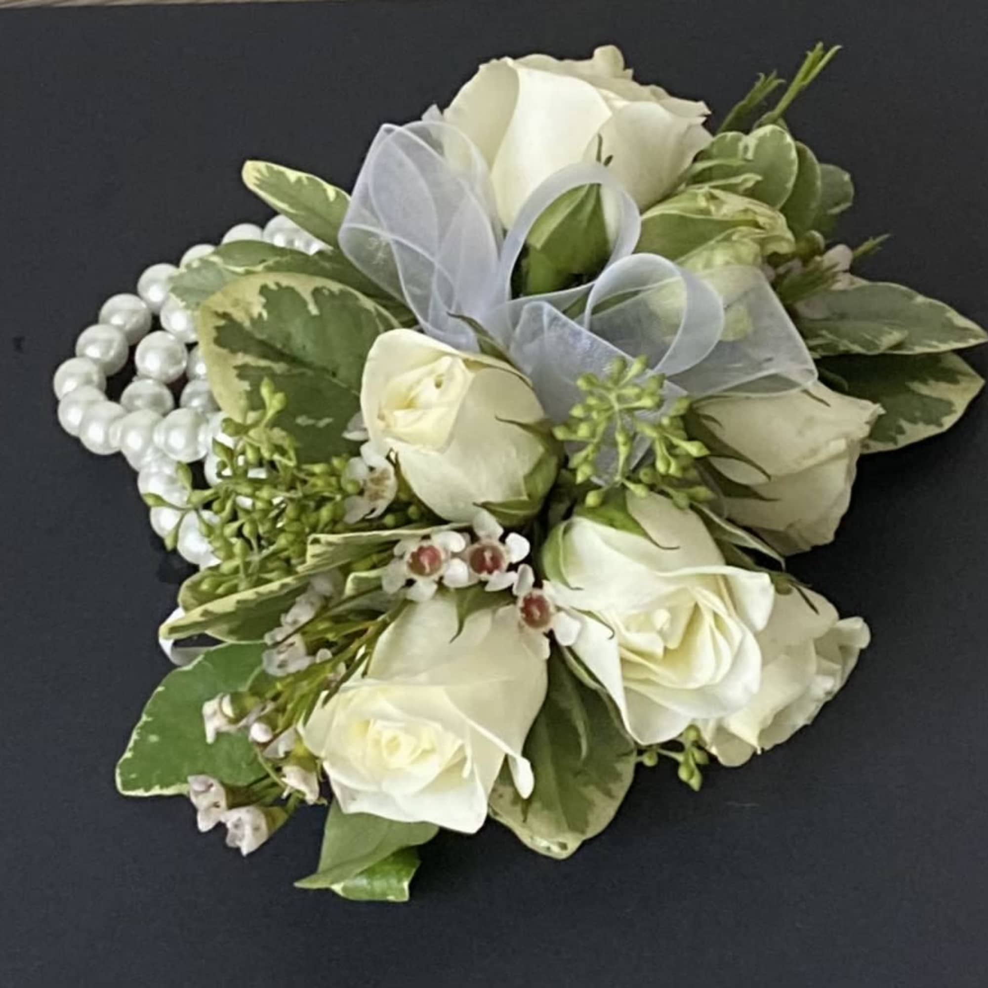 White rose corsage with pearl bracelet and sheer ribbon