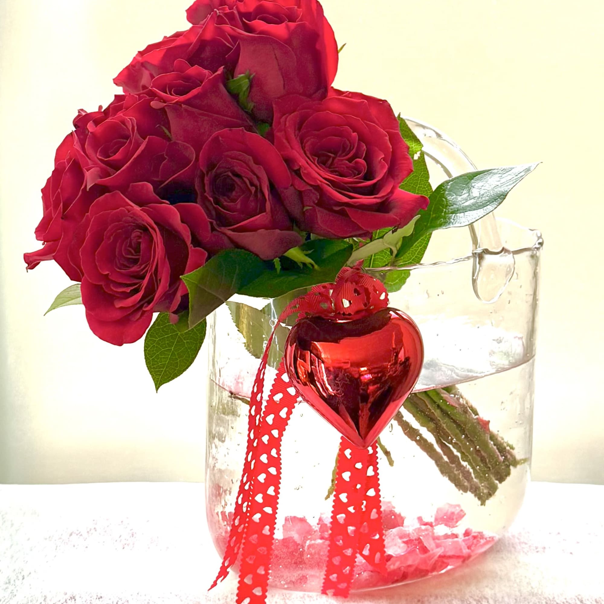 Red roses in a clear glass vase with a red heart ornament, photo 3 of 5