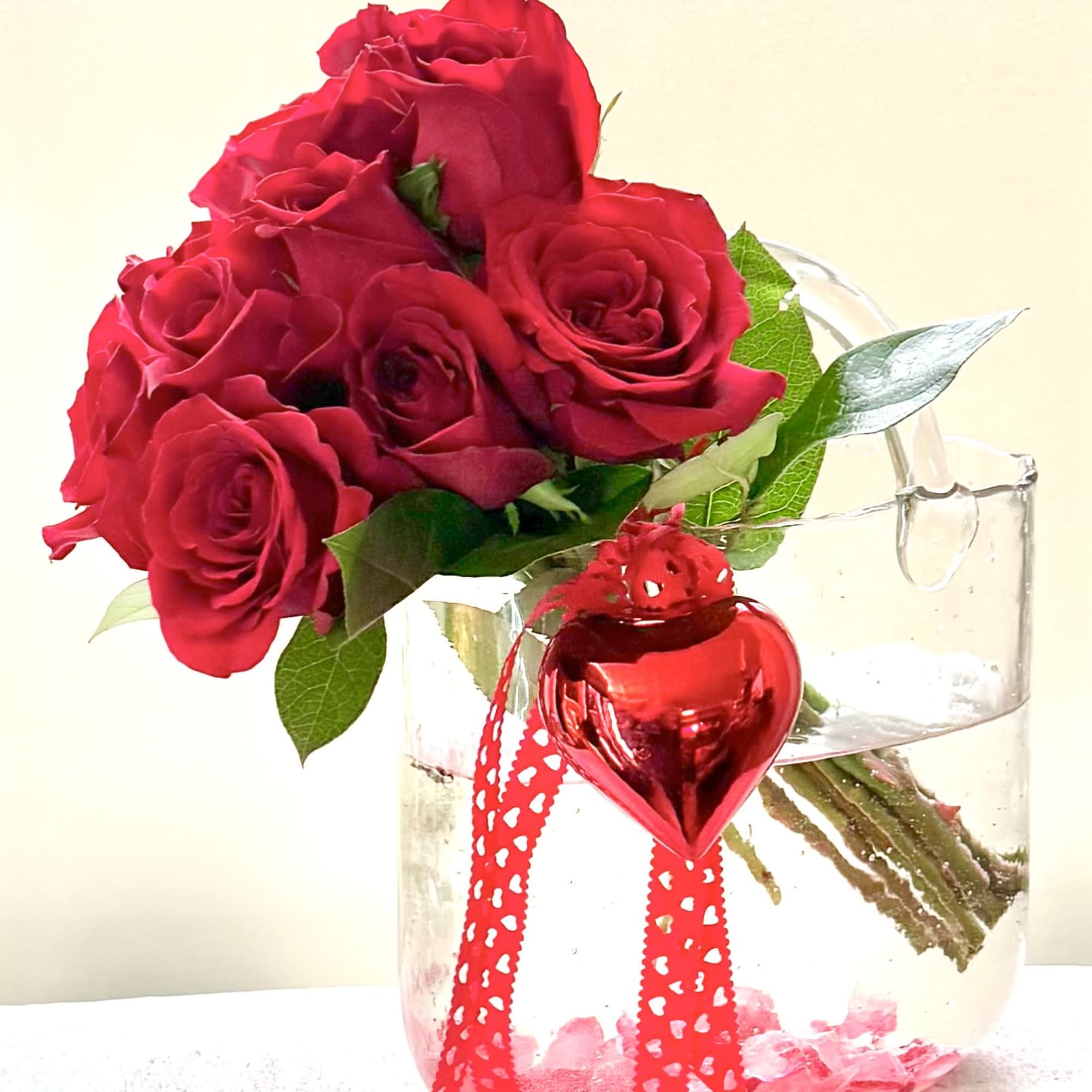 Red roses in a clear glass vase with a red heart ornament, photo 5 of 5