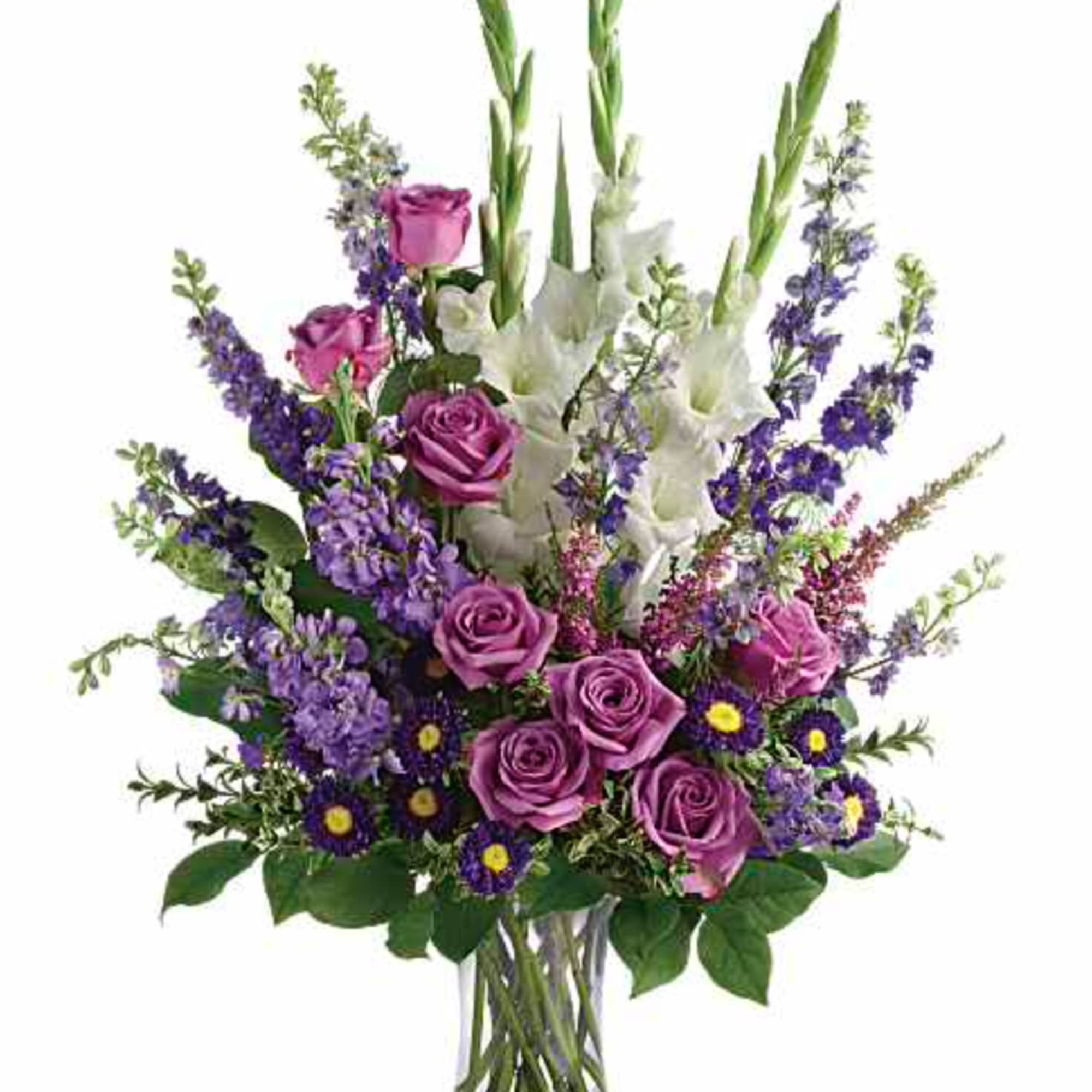 Purple roses and white gladiolus in a clear glass vase