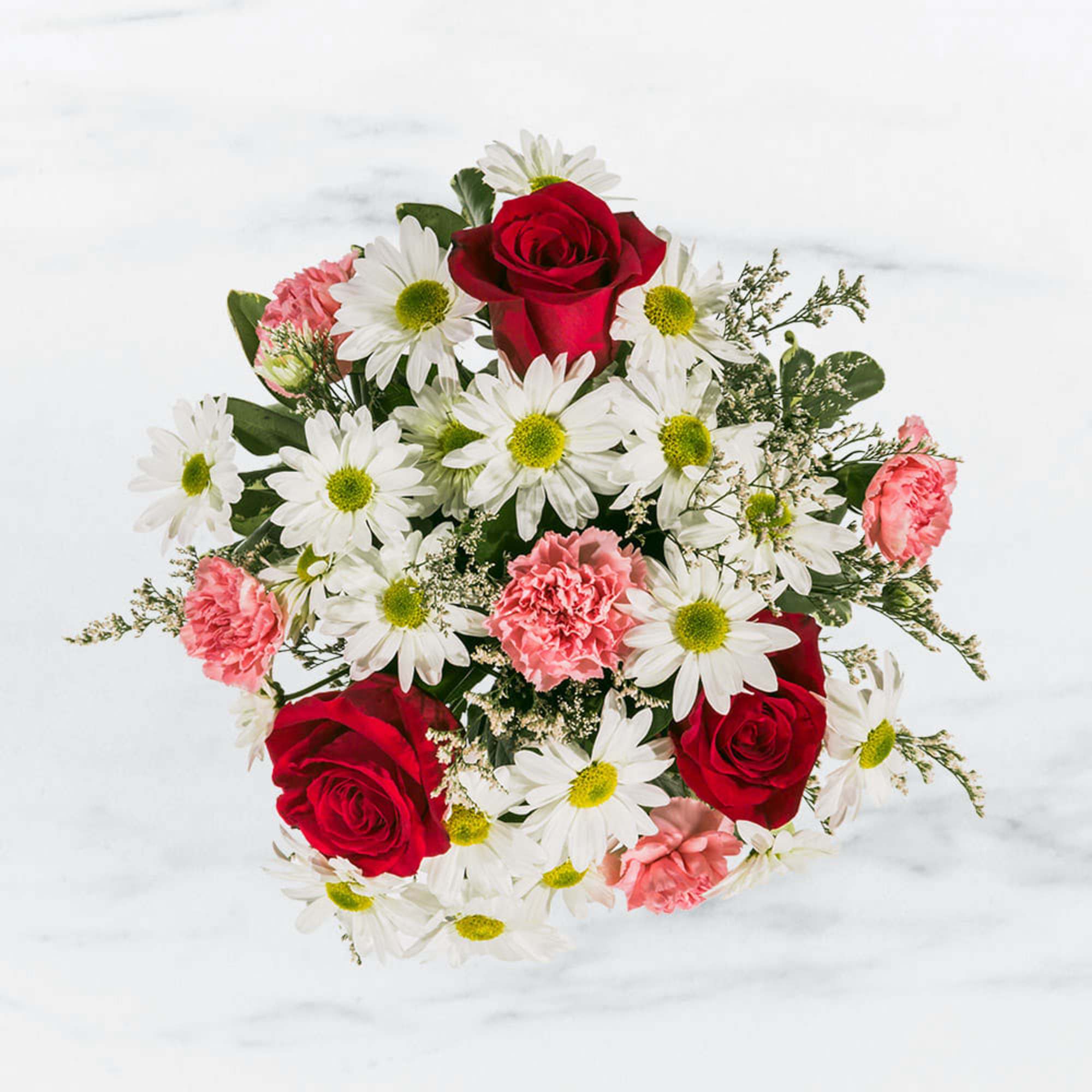 Bouquet of red roses, white daisies, and pink carnations