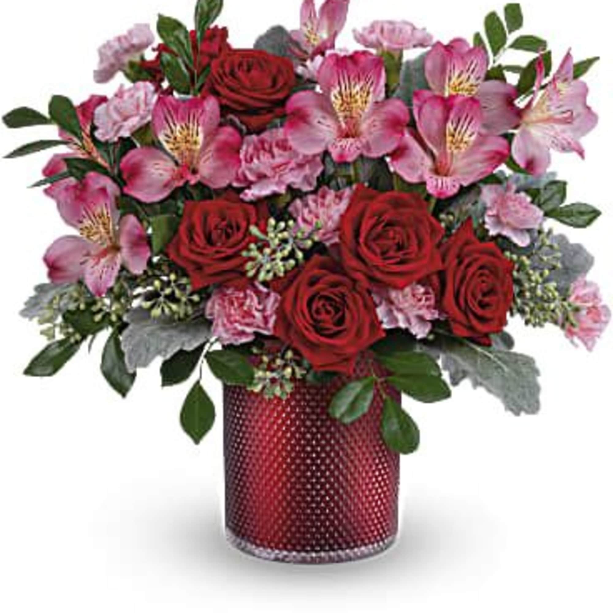 Red roses and pink alstroemeria in a red vase