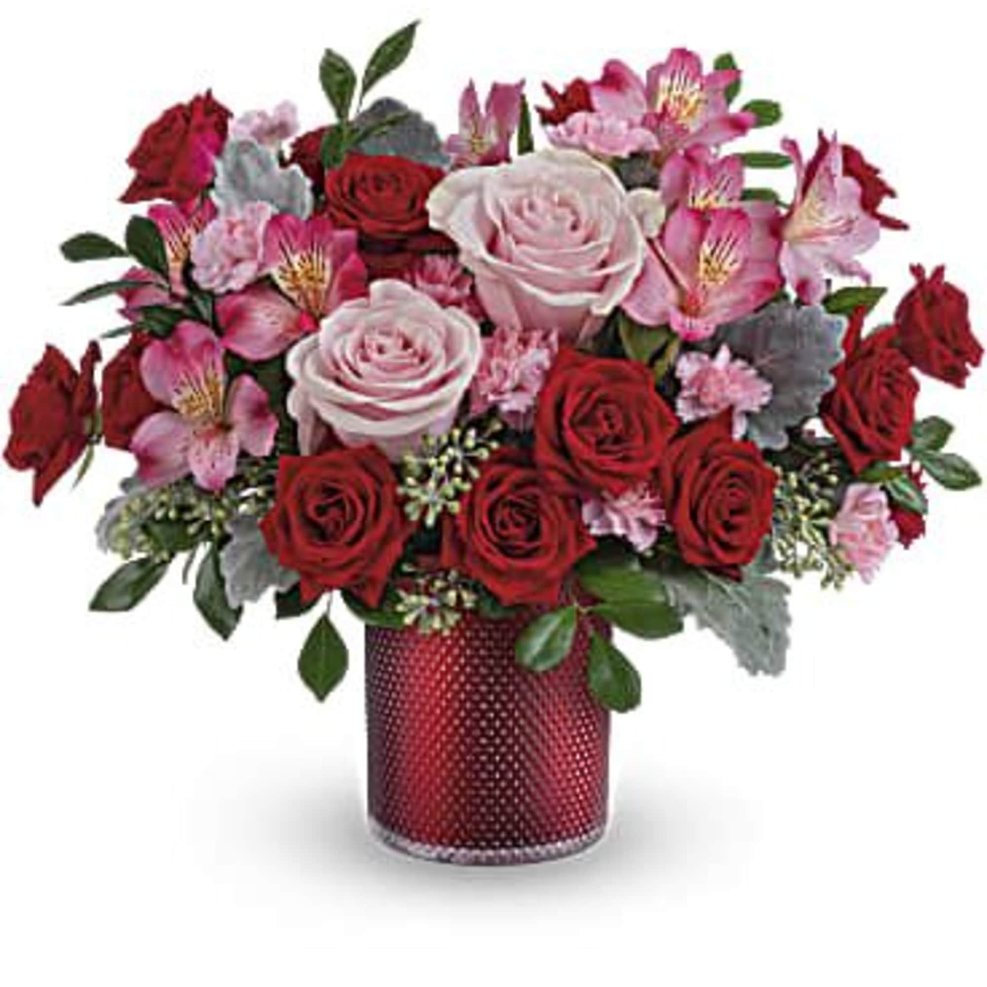 Red and pink rose bouquet in a red textured vase