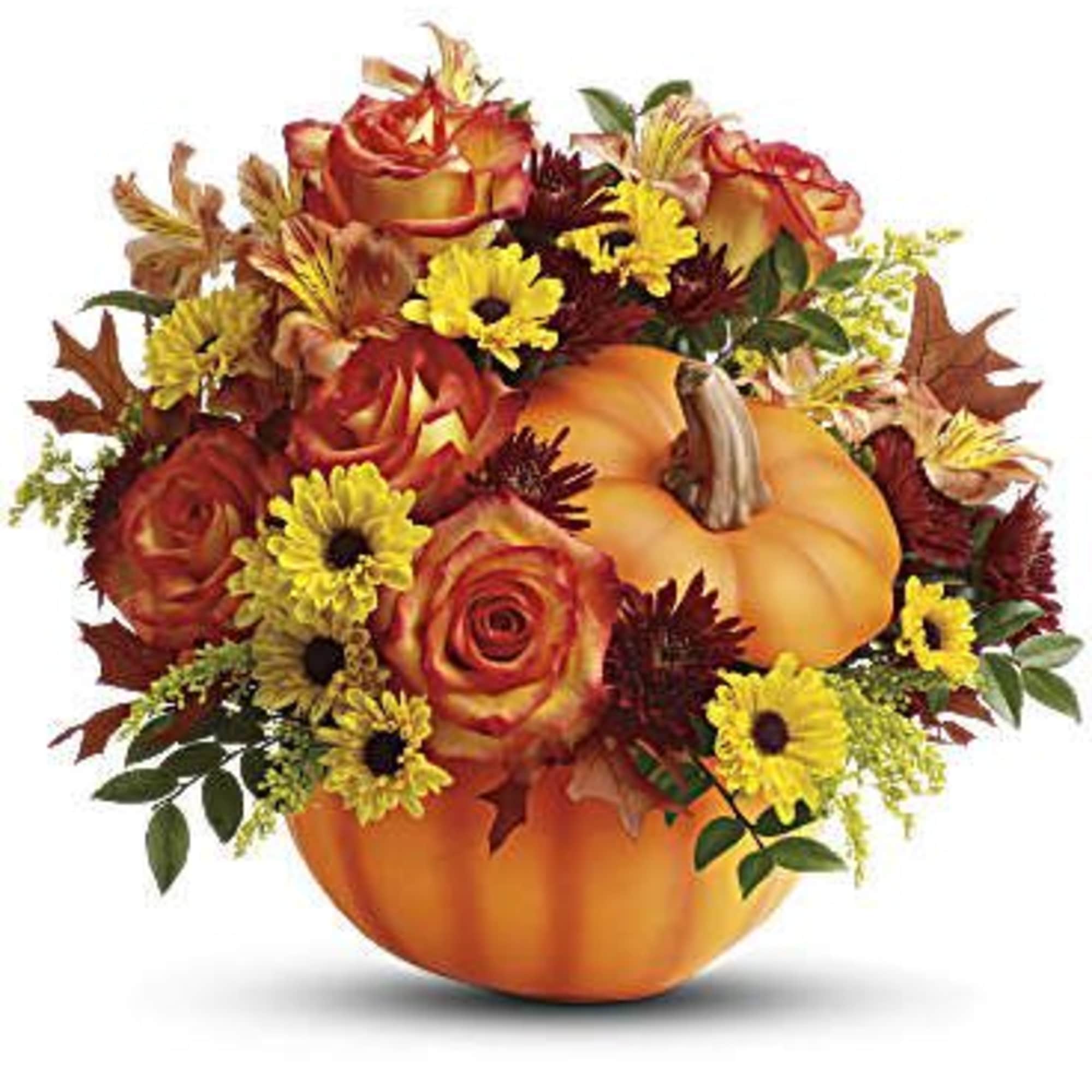 Autumn floral arrangement in a pumpkin-shaped container with orange roses and yellow daisies