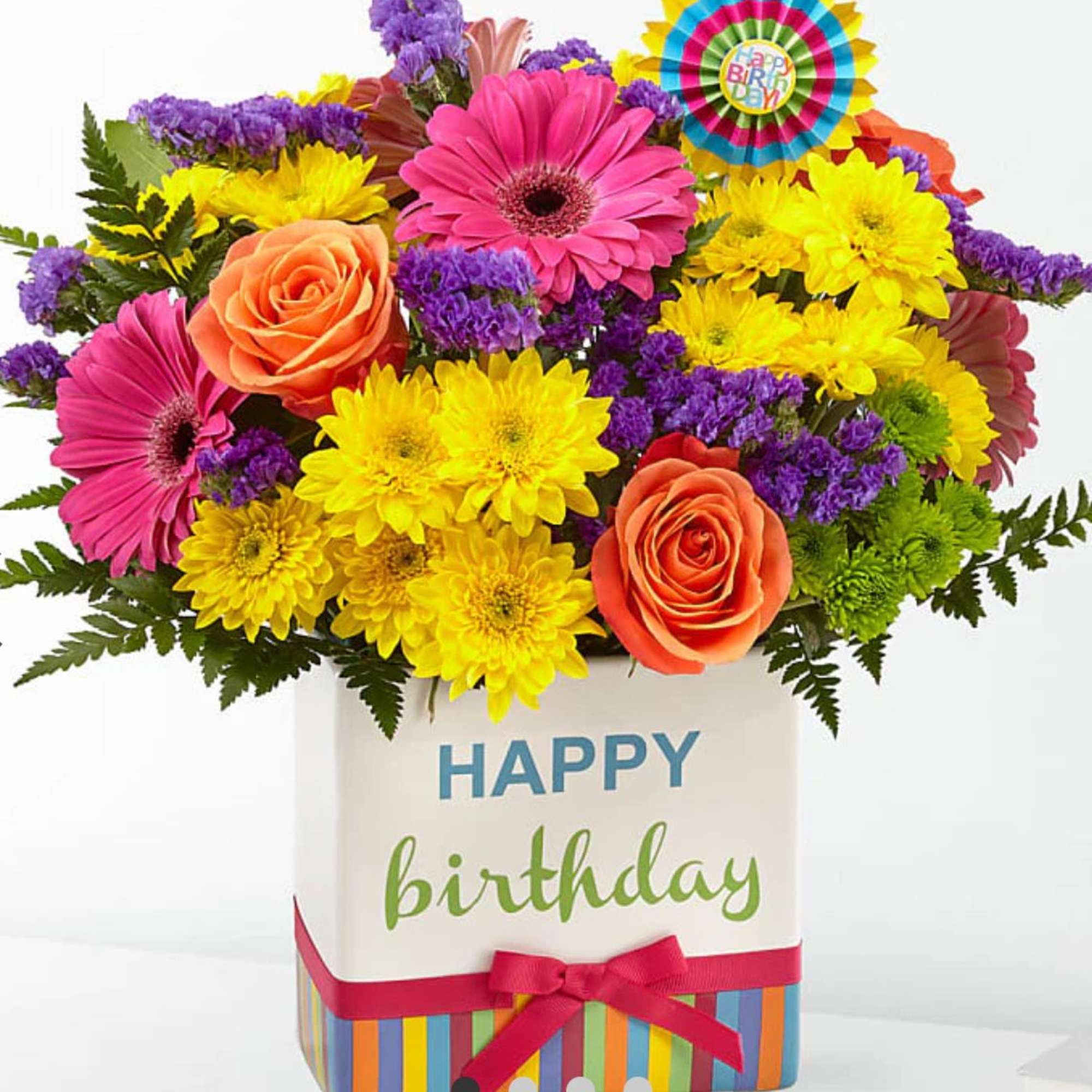 Bright mixed bouquet in a birthday gift box with a ribbon