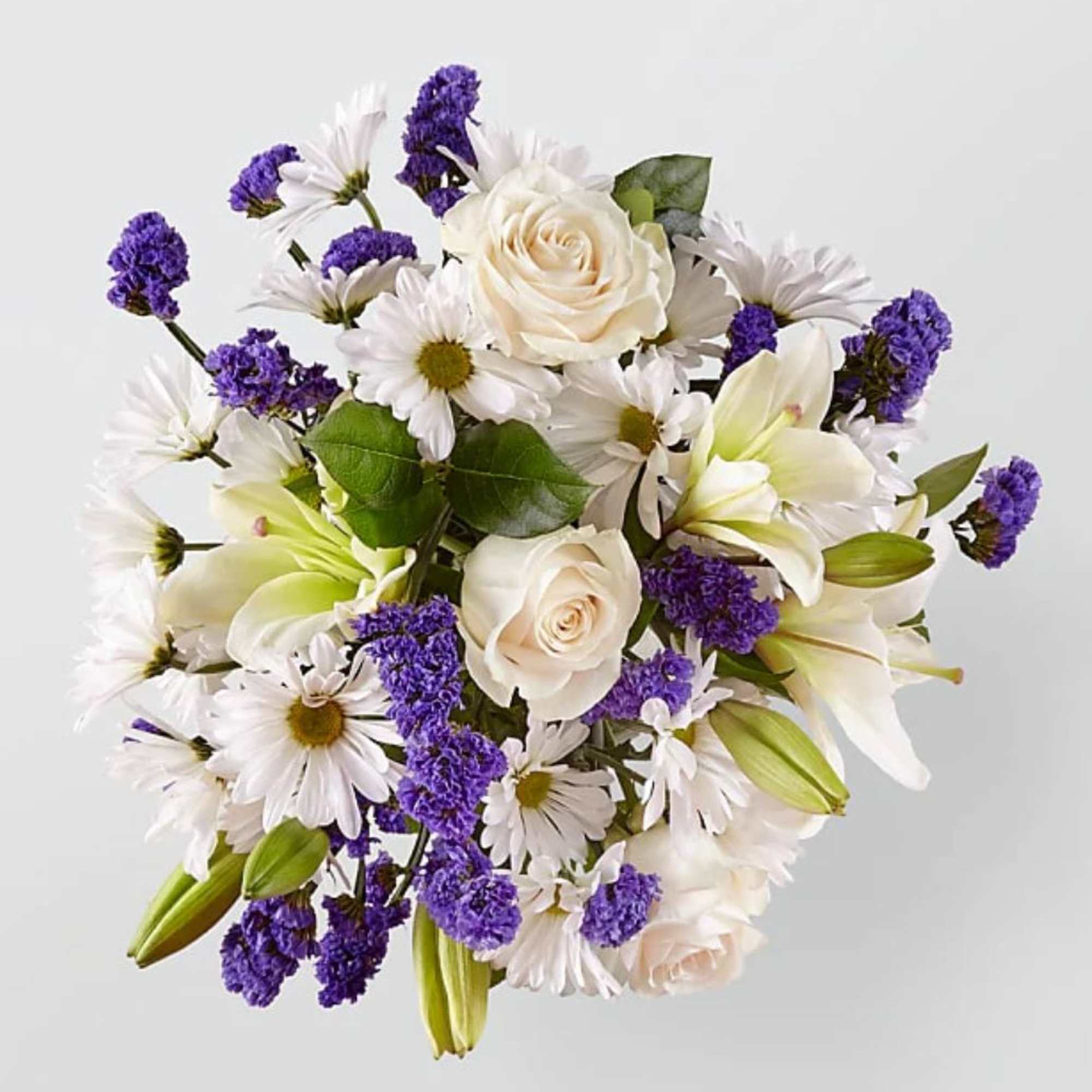 Bouquet of white roses, daisies, lilies, and purple filler flowers