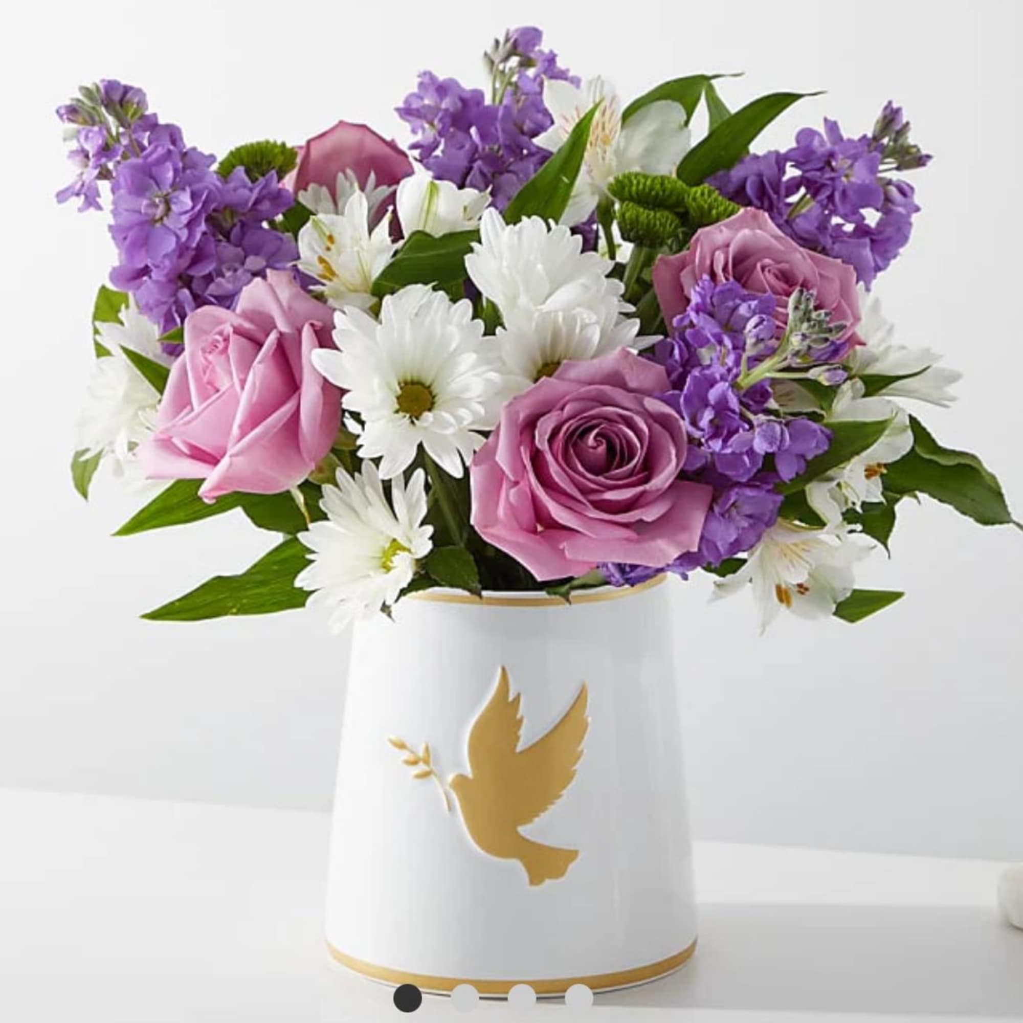Pink and purple roses with white daisies in a white vase