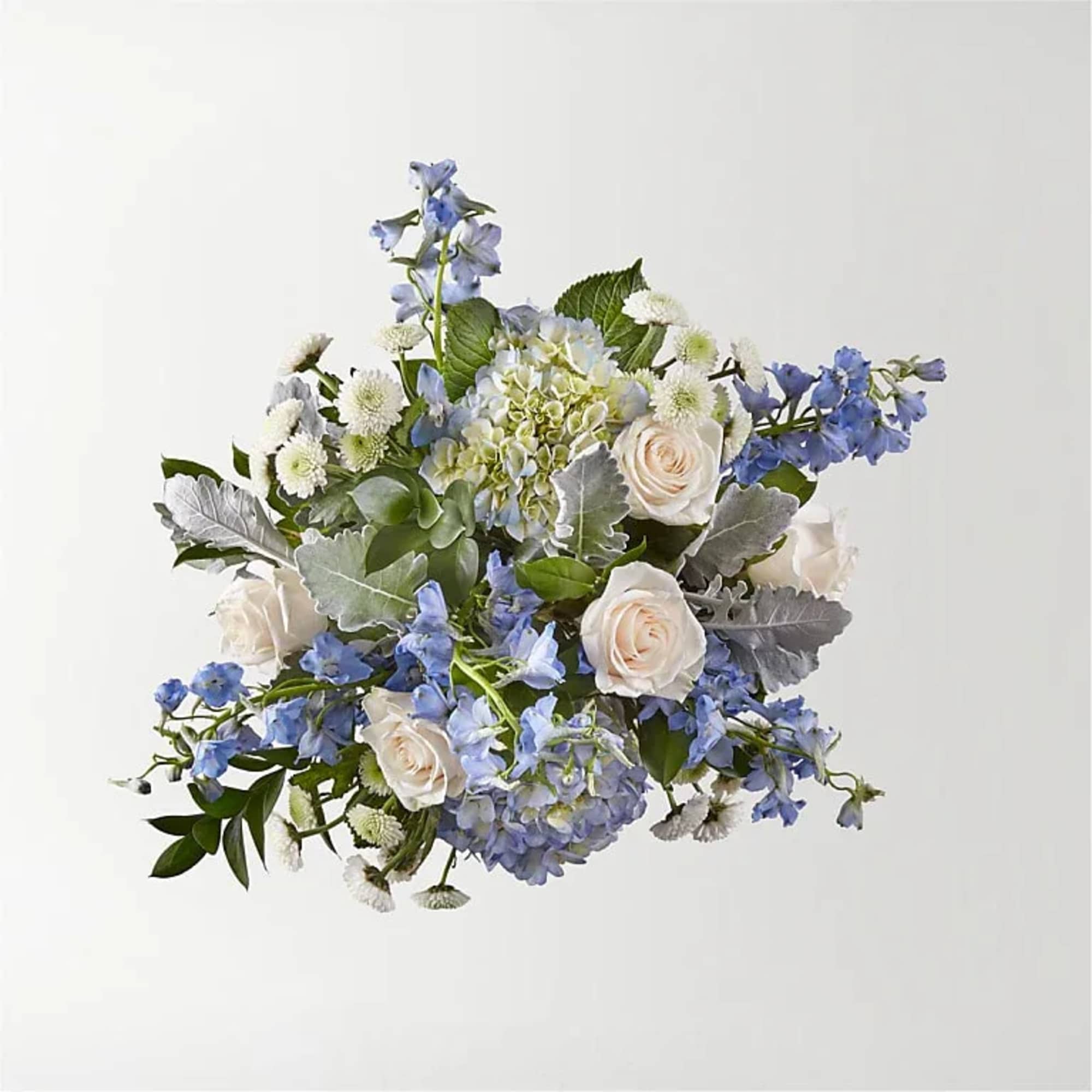 Bouquet of white roses, blue flowers, and hydrangea
