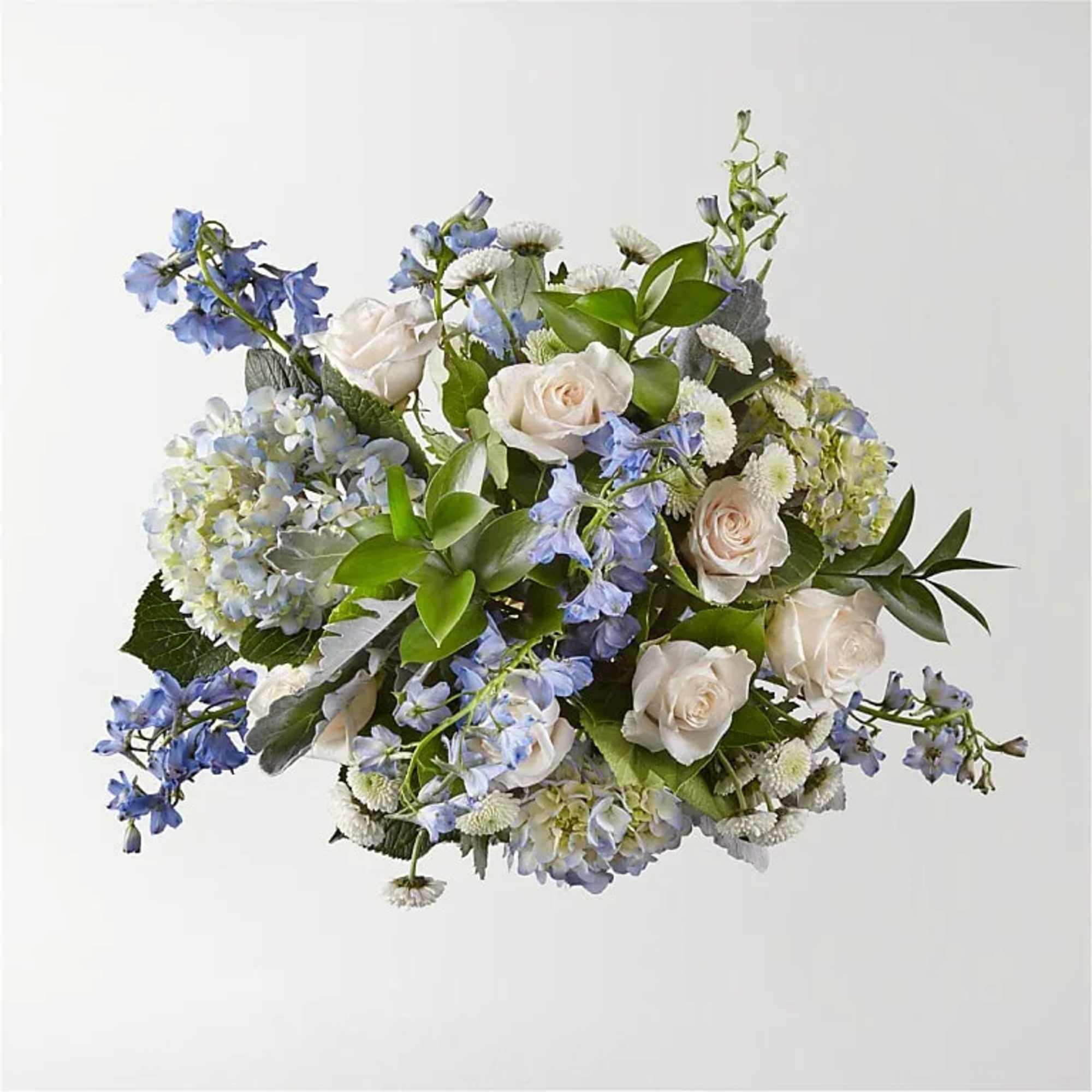 Bouquet of white roses and blue flowers with greenery