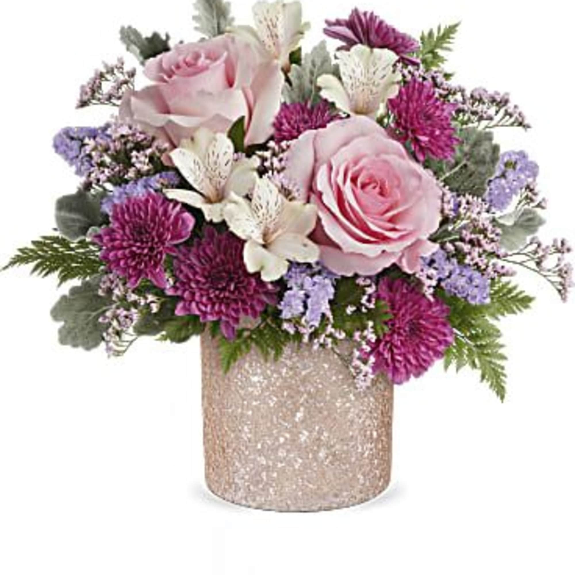Pink roses and purple blooms arranged in a glittery vase