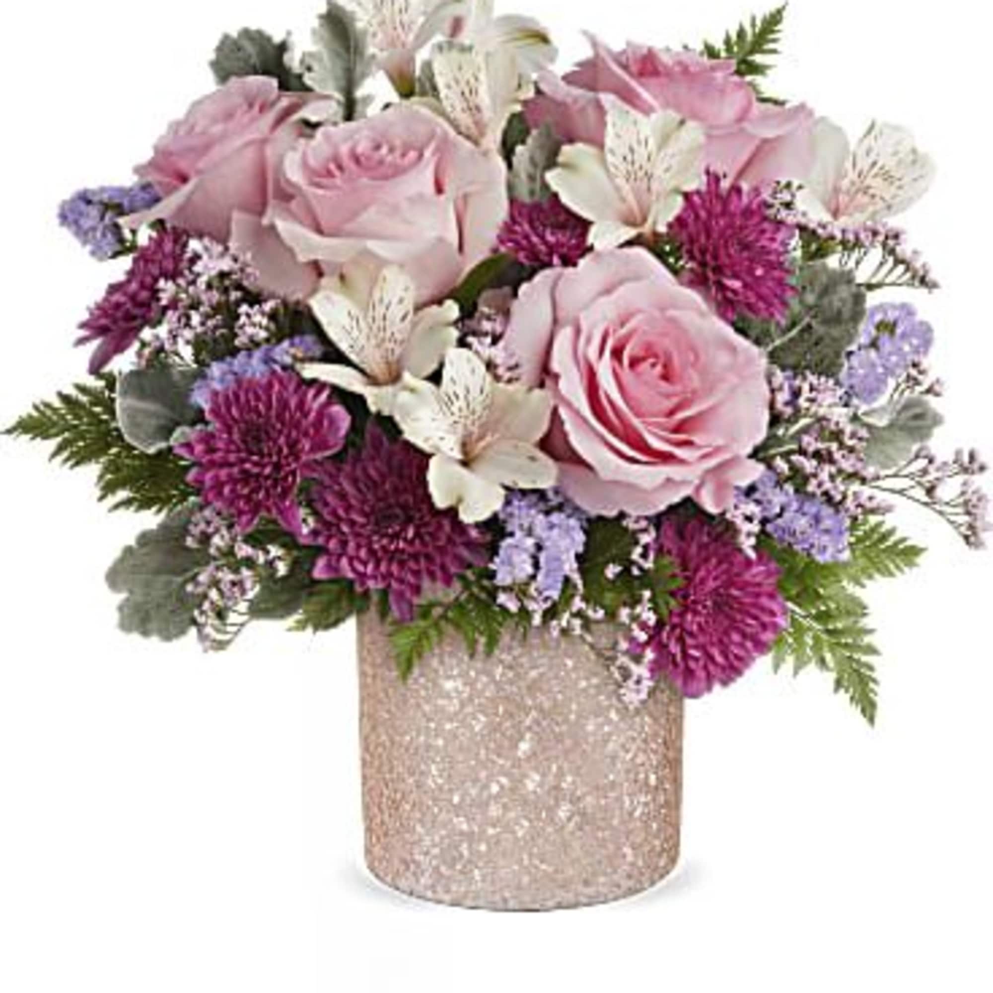 Pink roses and purple flowers arranged in a glittery vase