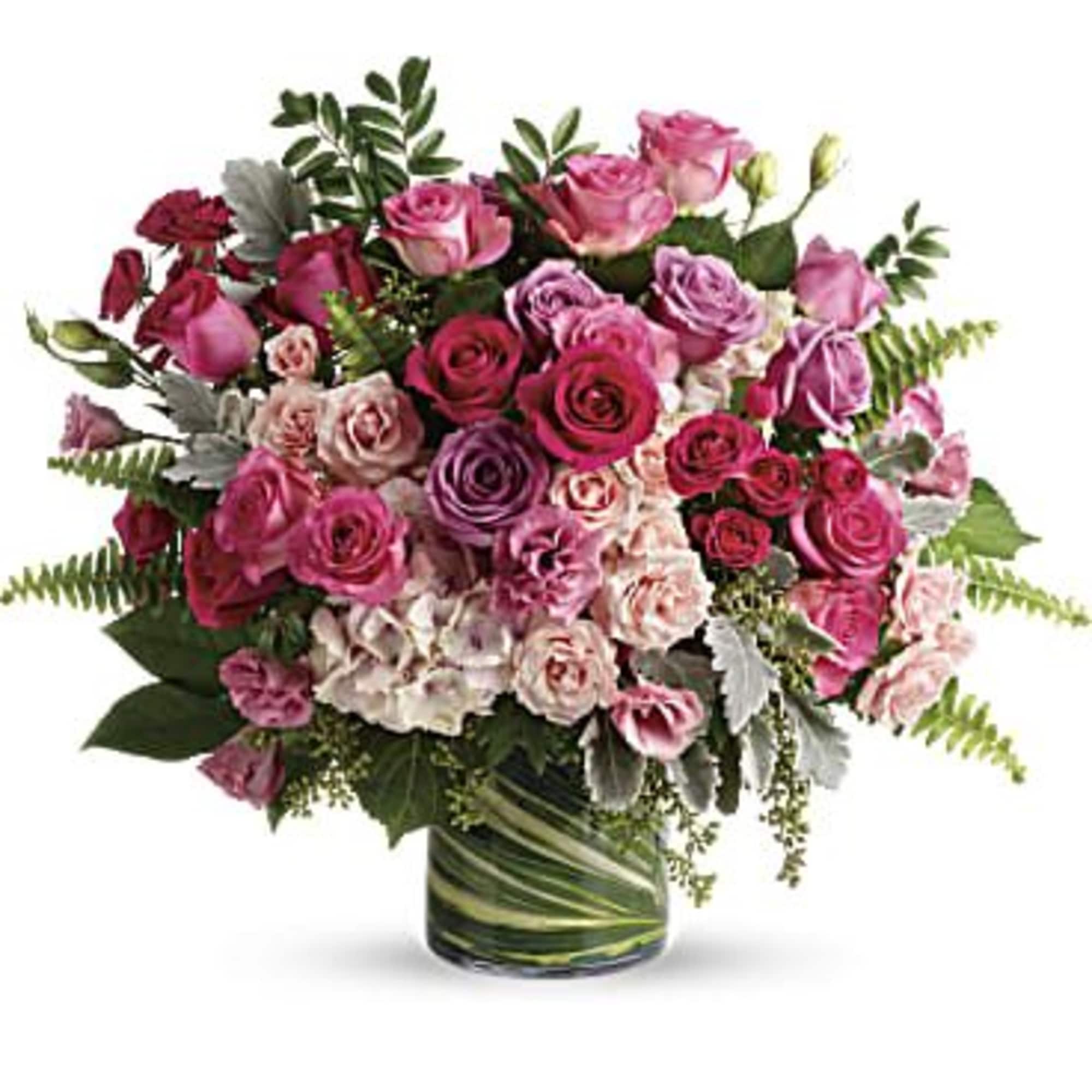 Bouquet of pink and purple roses in a glass vase