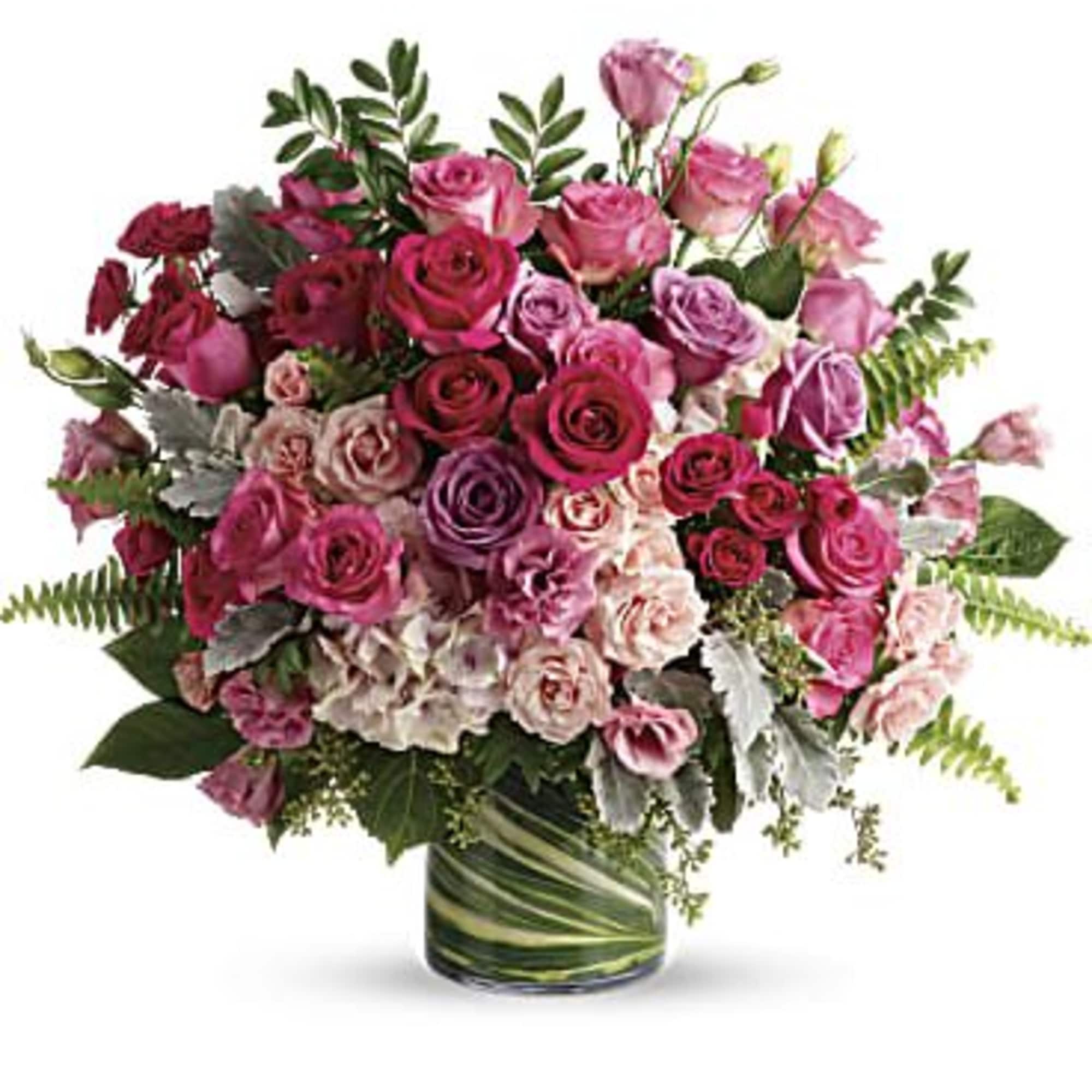 Bouquet of pink and purple roses in a glass vase