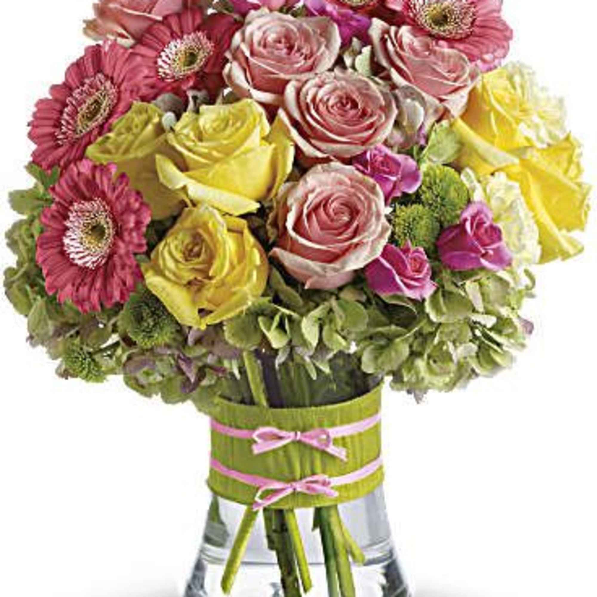 Bouquet of pink and yellow roses with pink gerbera daisies in a glass vase