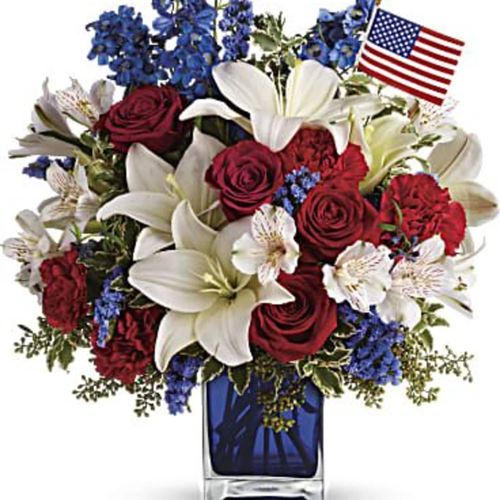 Bouquet of red roses and white lilies in a blue vase with an American flag
