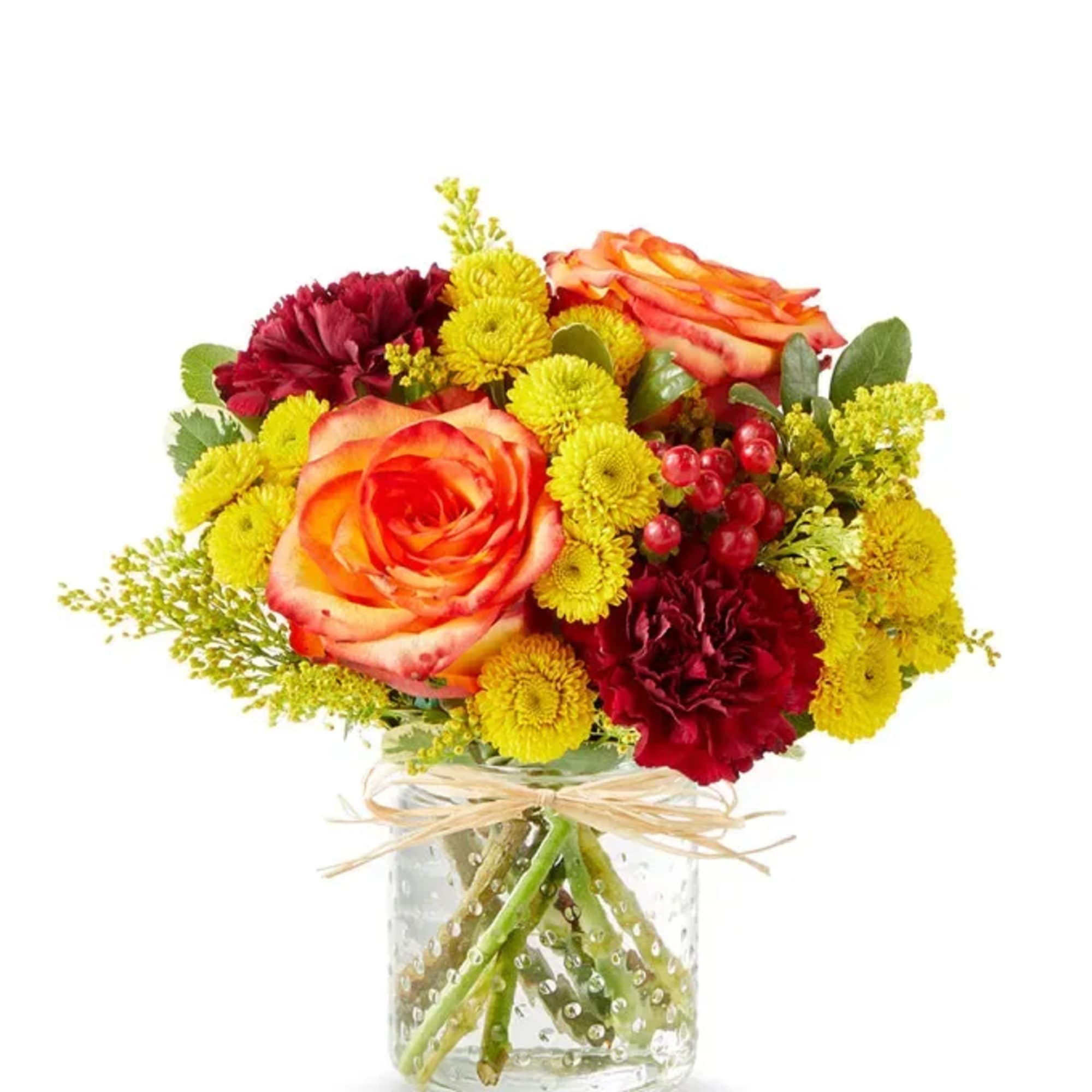 Bouquet of orange roses and yellow and burgundy flowers in a glass vase