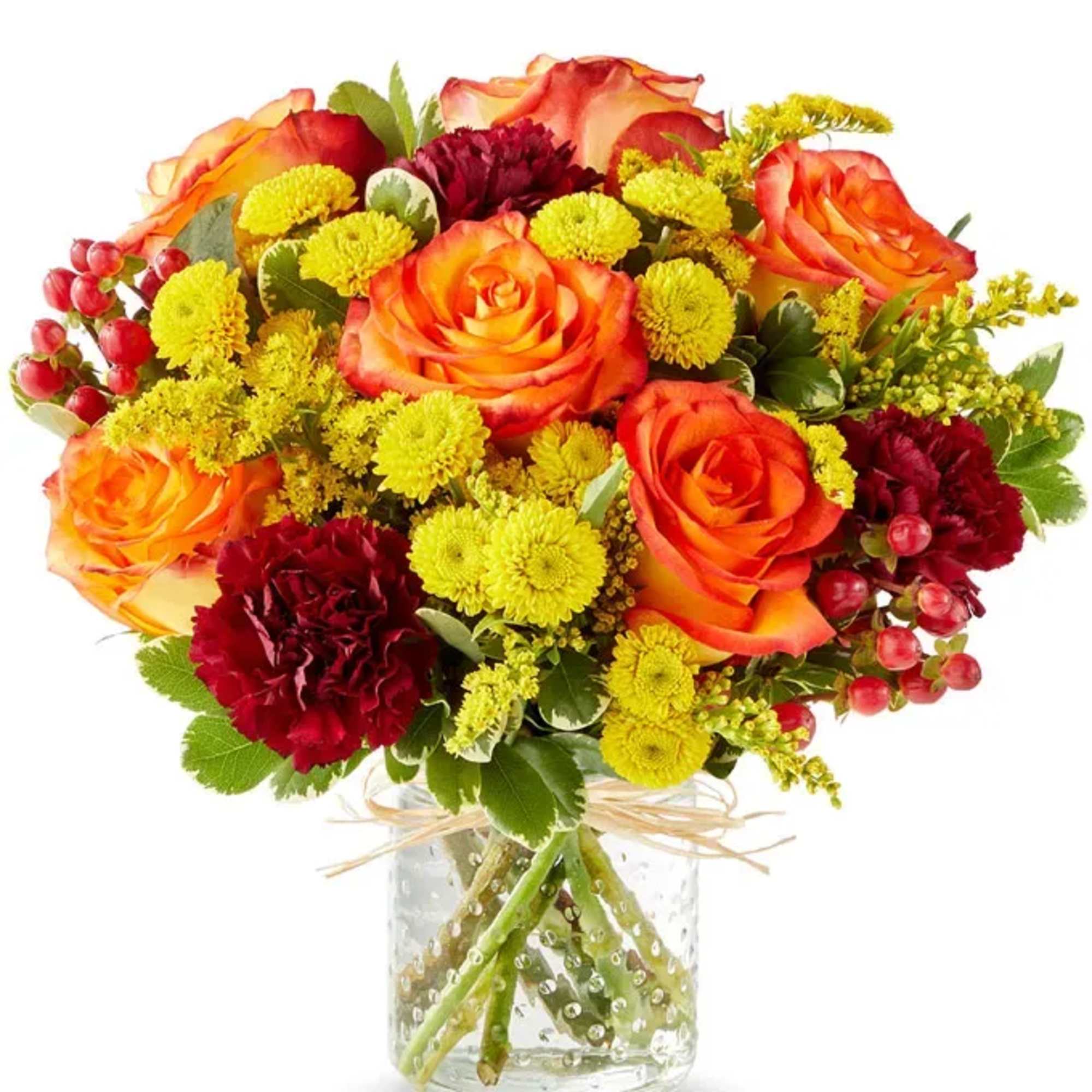 Bouquet of orange roses and yellow chrysanthemums in a clear glass vase