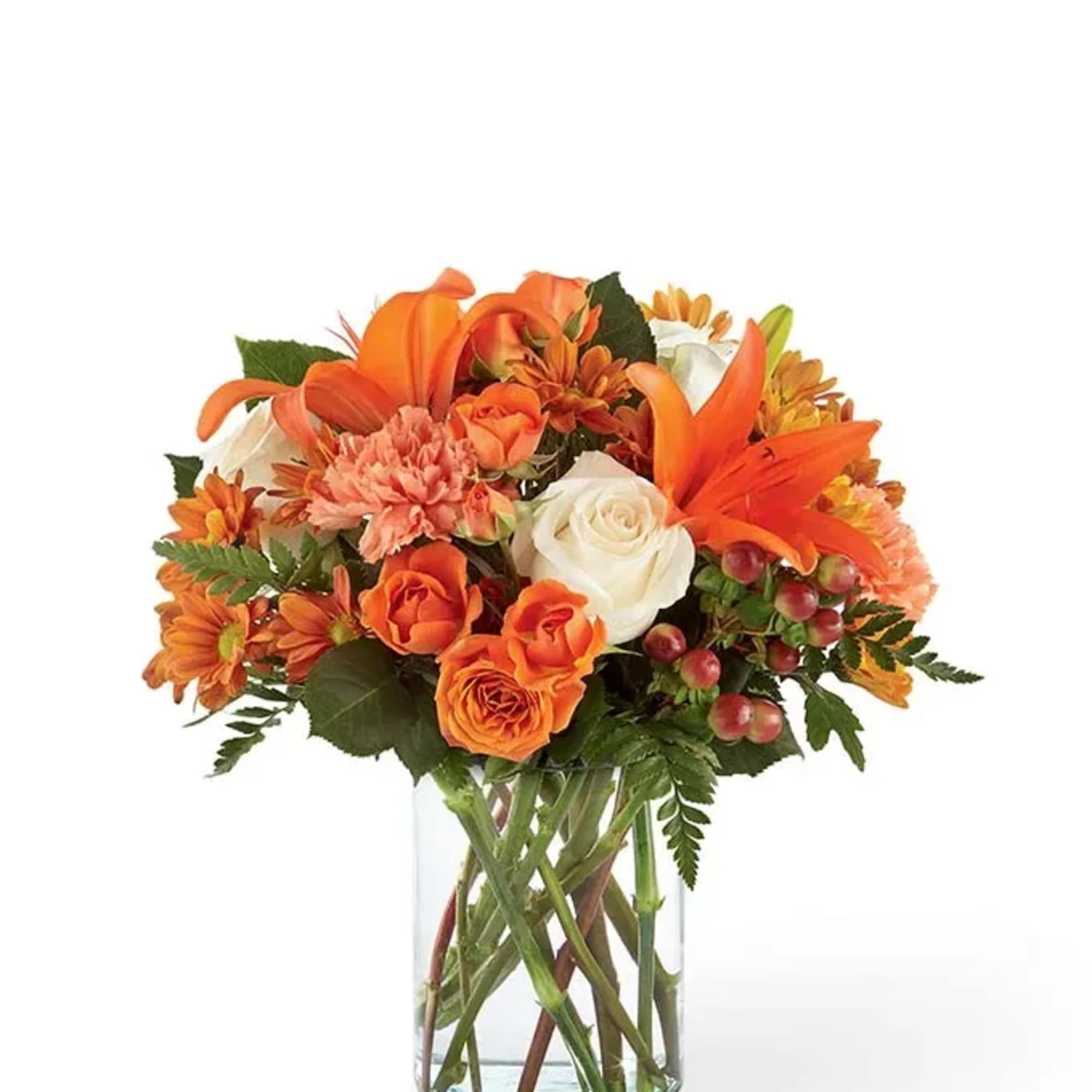Orange and white flower bouquet in a clear glass vase