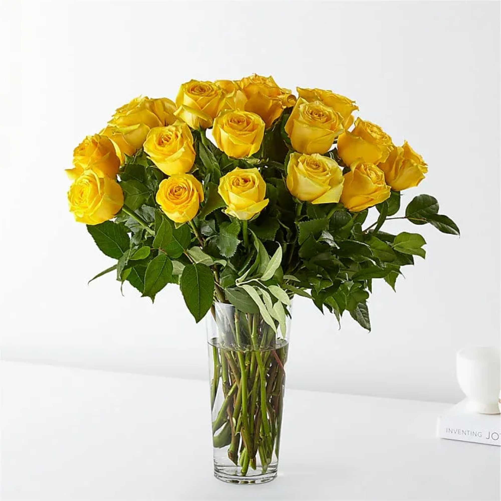 Yellow roses arranged in a clear glass vase
