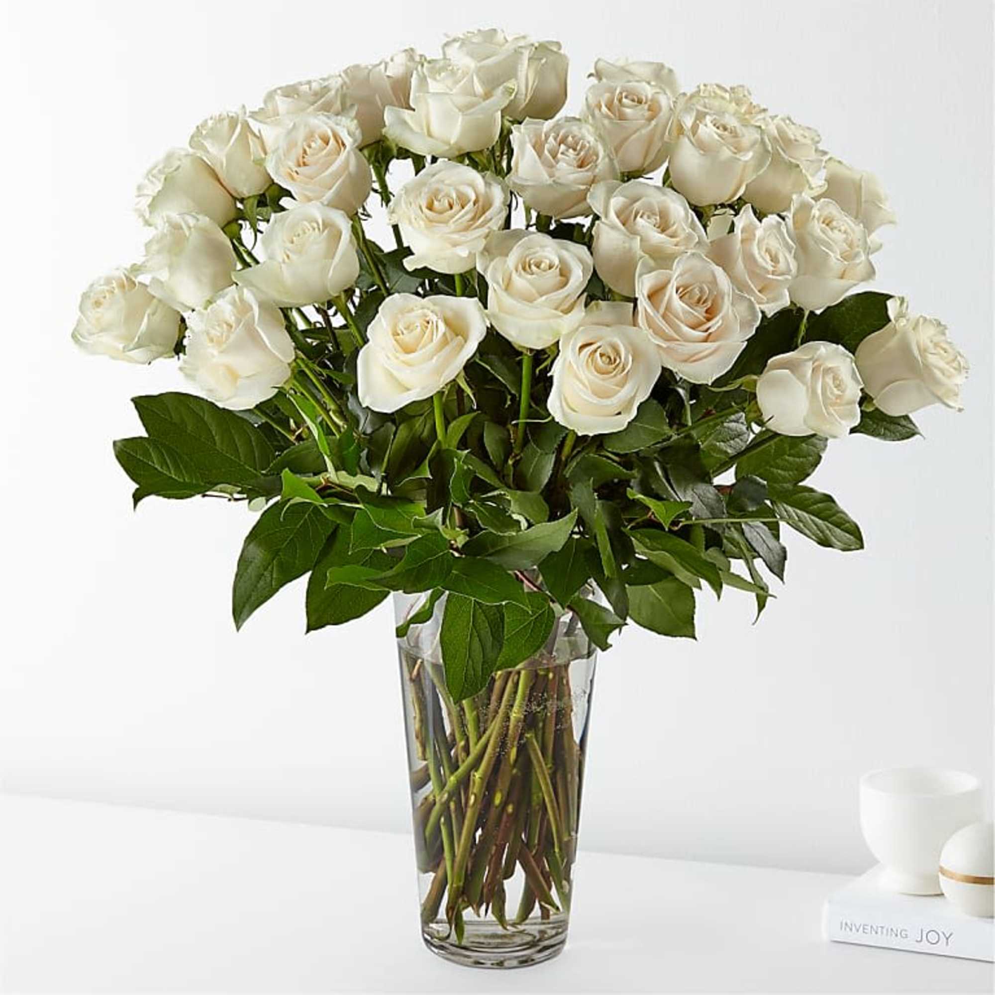 Bouquet of white roses in a clear glass vase