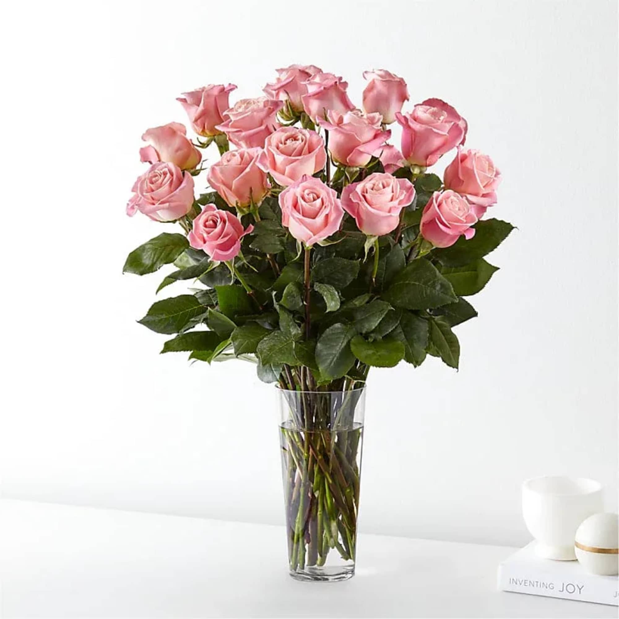 Pink roses arranged in a clear glass vase