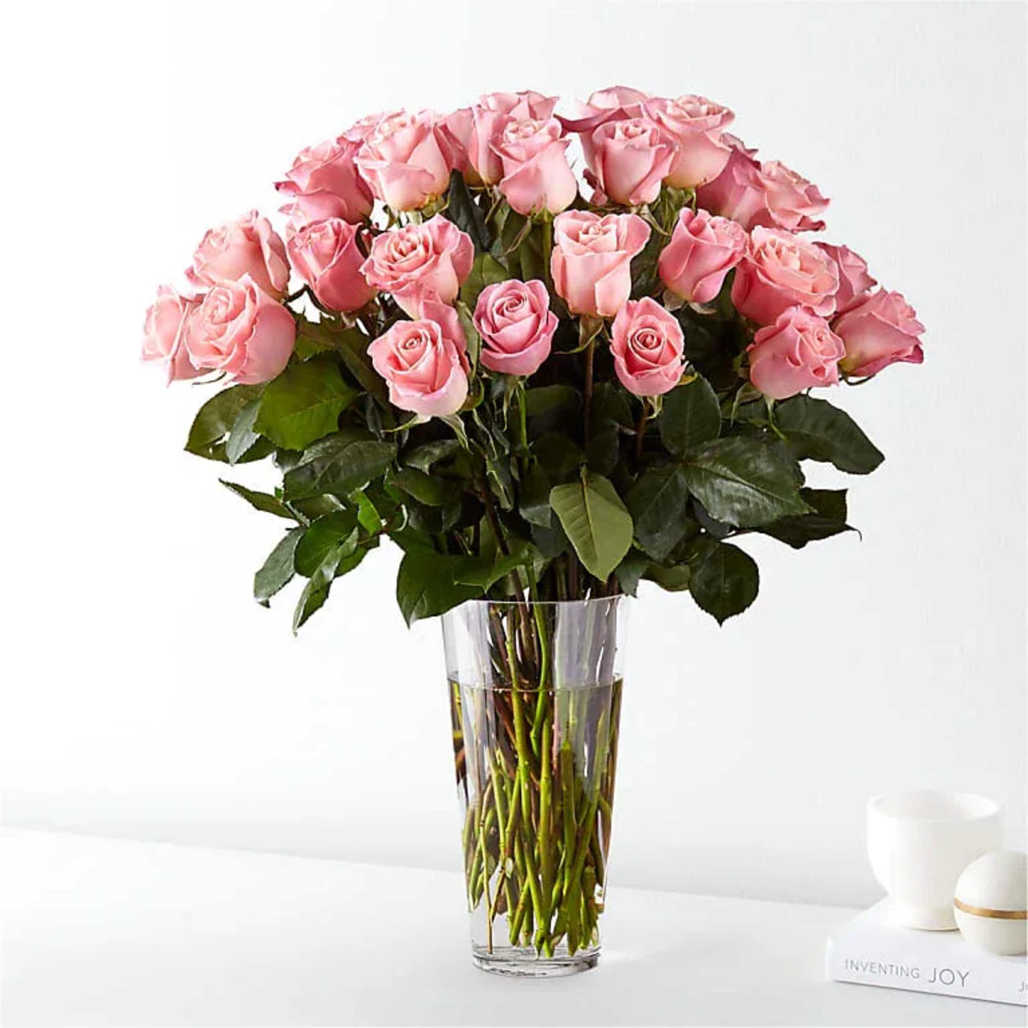 Bouquet of pink roses in a clear glass vase
