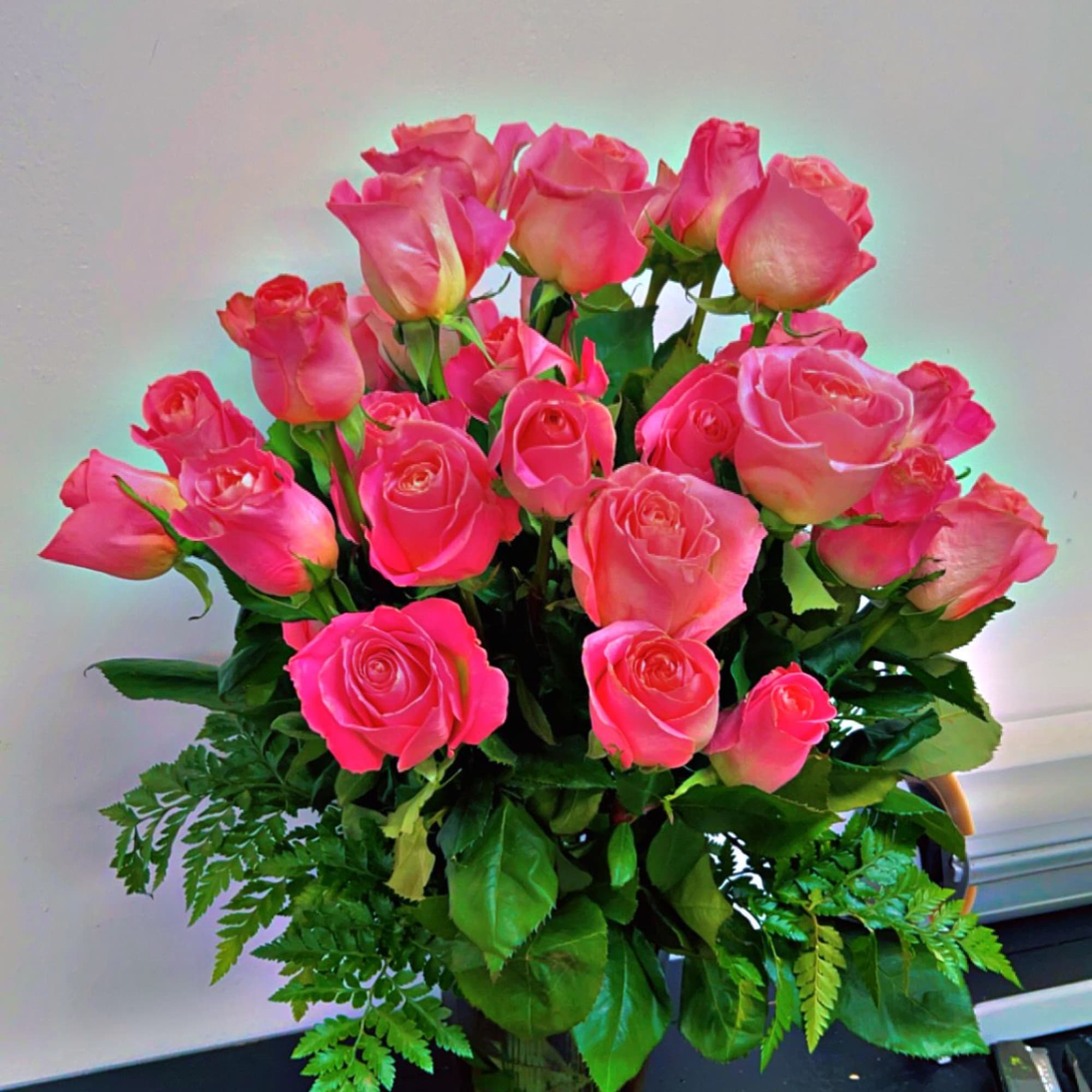 Pink roses arranged in a clear glass vase