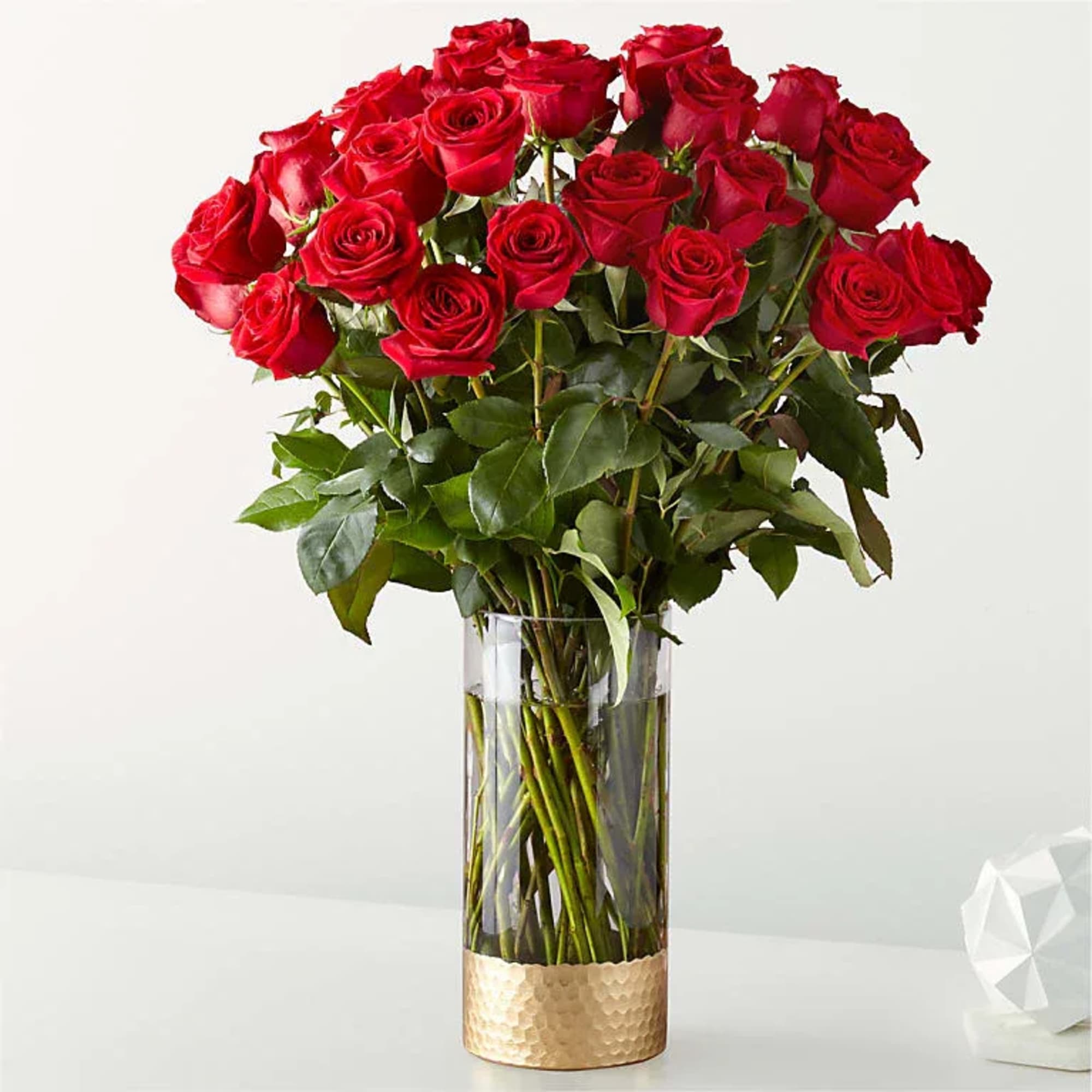 Bouquet of red roses in a tall clear glass vase